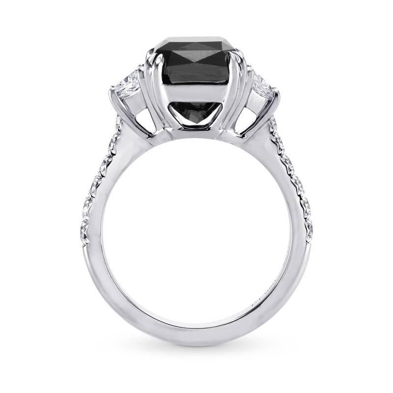 A 6.34Ct TW Natural unheated Fancy Black diamond engagement ring certified by GIA, mounted in a Trapezoid and pave diamond ring setting, in all Platinum.
The center diamond is certified by GIA as Natural Fancy Black Cut-cornered Rectangular