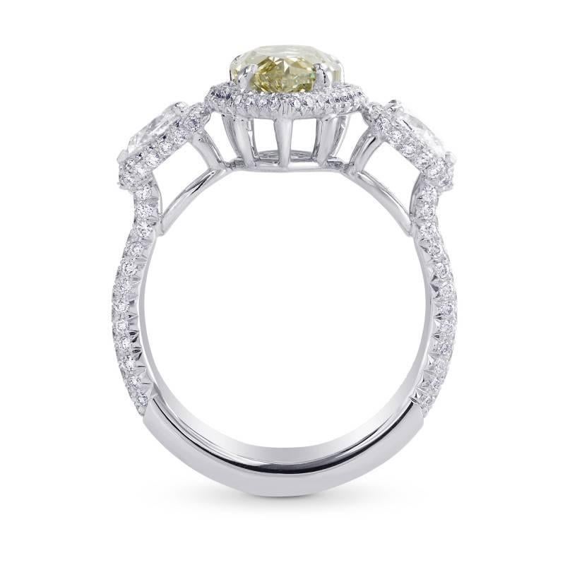 A beautiful three-stone halo ring with a 2.02-carat Fancy Grayish Yellowish Green (VS) clarity Pear Shape center stone, certified by GIA and mounted in Platinum. The ring includes  0.46cts F+ color side stones and 0.56cts diamonds set with a French