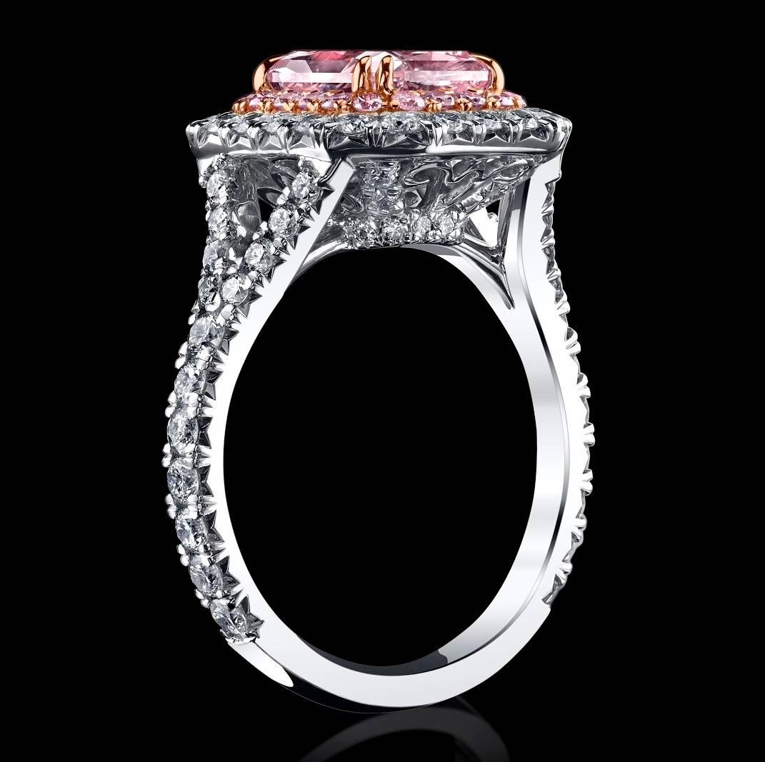 A gorgeous Pink Diamond Ring with a rare sweet Pink tone. The Center Diamond is a Natural Fancy Light Orangy Pink Diamond, surrounded with a halo of Natural Pink diamonds melee, enhancing the beauty and the color of the center stone. A second halo