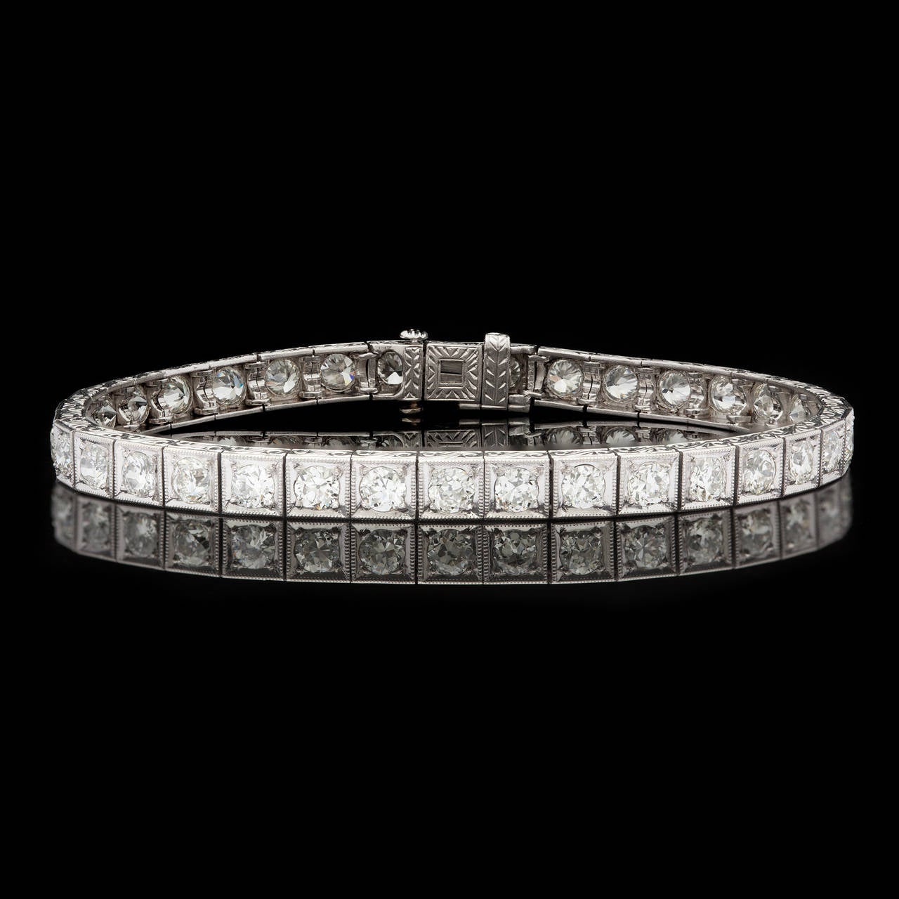 Platinum Art Deco Straight Line Bracelet Features 36 Old European Diamonds set in  engraved and milgrained edged box links. The total diamond weight is approximately 5.76 carats. The bracelet is just over 7.0 inches long and measures 5mm wide. The