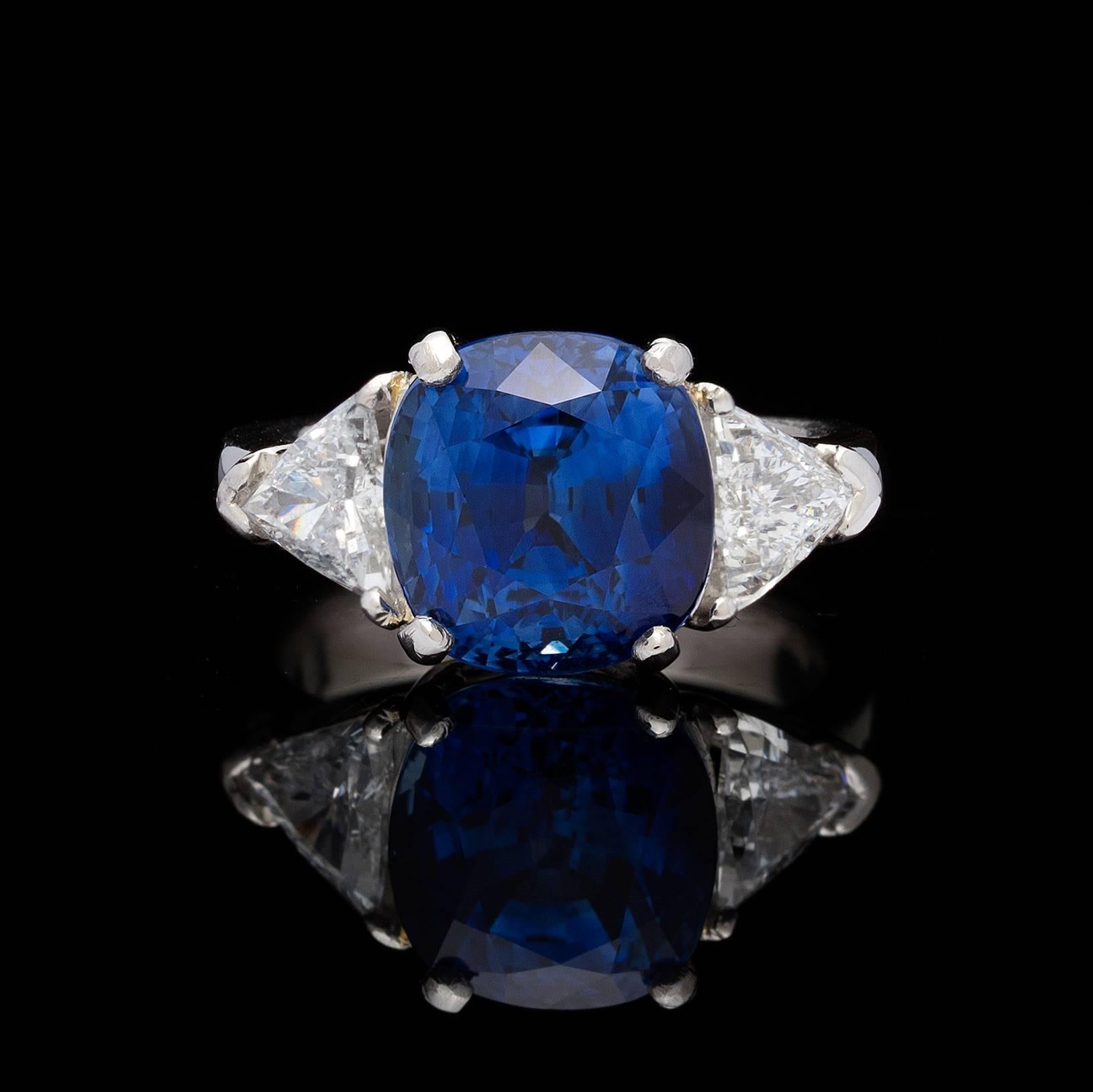 A beautiful platinum estate ring featuring an AGL 6.60 carats square cushion mixed-cut Madagascar blue sapphire flanked by two triangular brilliant-cut diamonds weighing together approximately 1.06 carats.  The ring is currently a 5.5 with room to