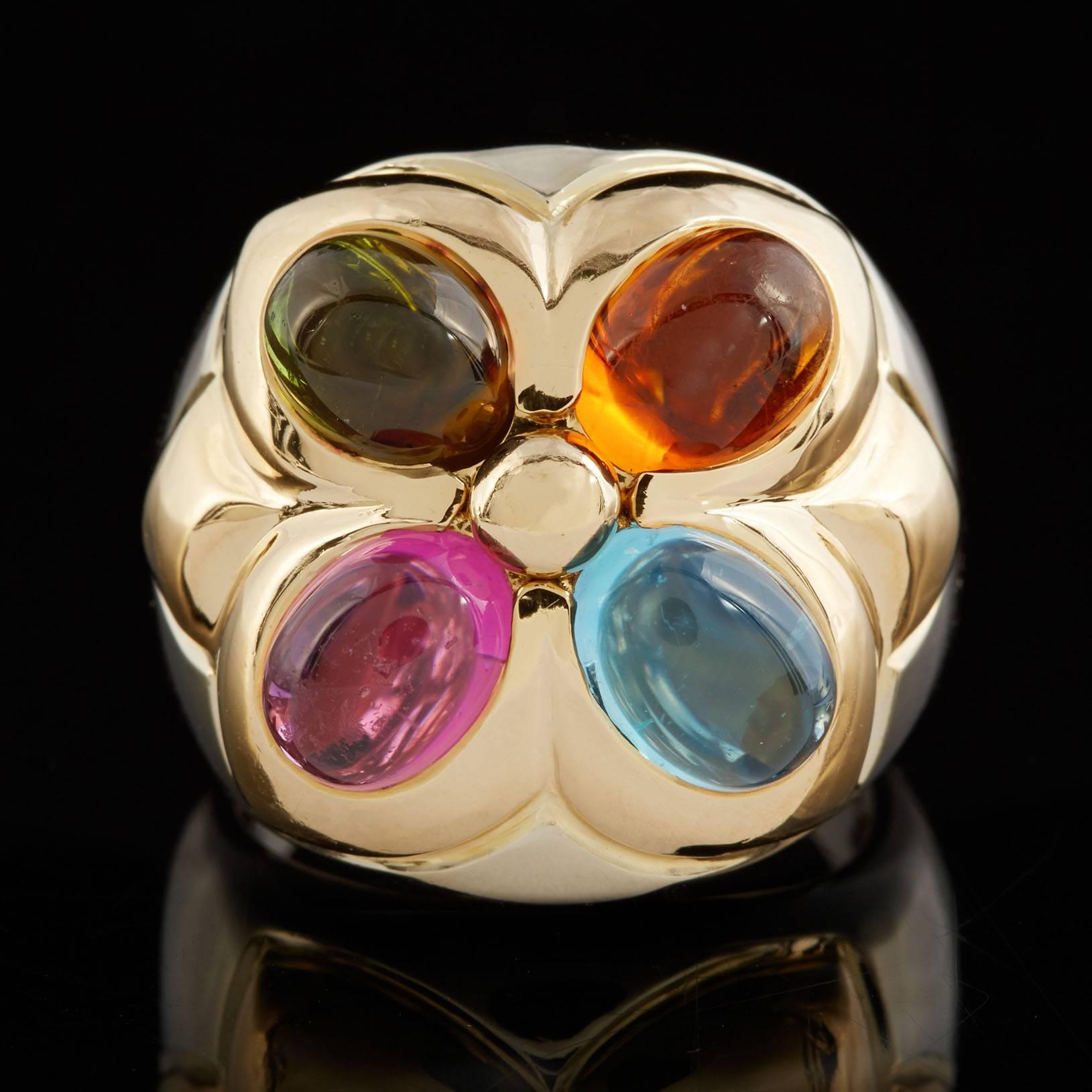 Bulgari 18k yellow gold statement ring features four cabochon-cut blue topaz, green and pink tourmaline, and citrine. The ring measures 20.5mm, tapering to 3.5mm at the back. Currently it fits a size 7, can be adjusted up or down, and weighs 17.7