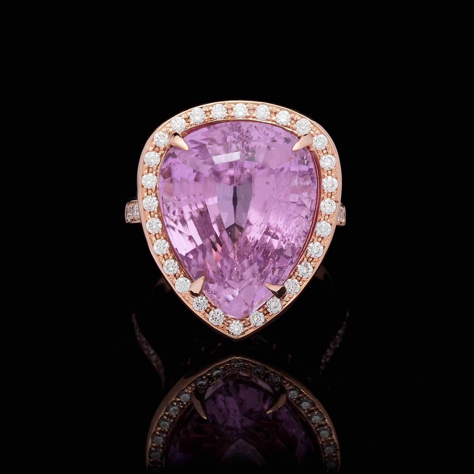 A gorgeous 17.64ct pear shape kunzite in a contemporary 18k rose gold setting with 44 round brilliant cut diamonds, totaling 0.57cttw. The ring is currently a size 6 and can be sized up or down.  This piece weighs 11.8 grams.  An intense purplish