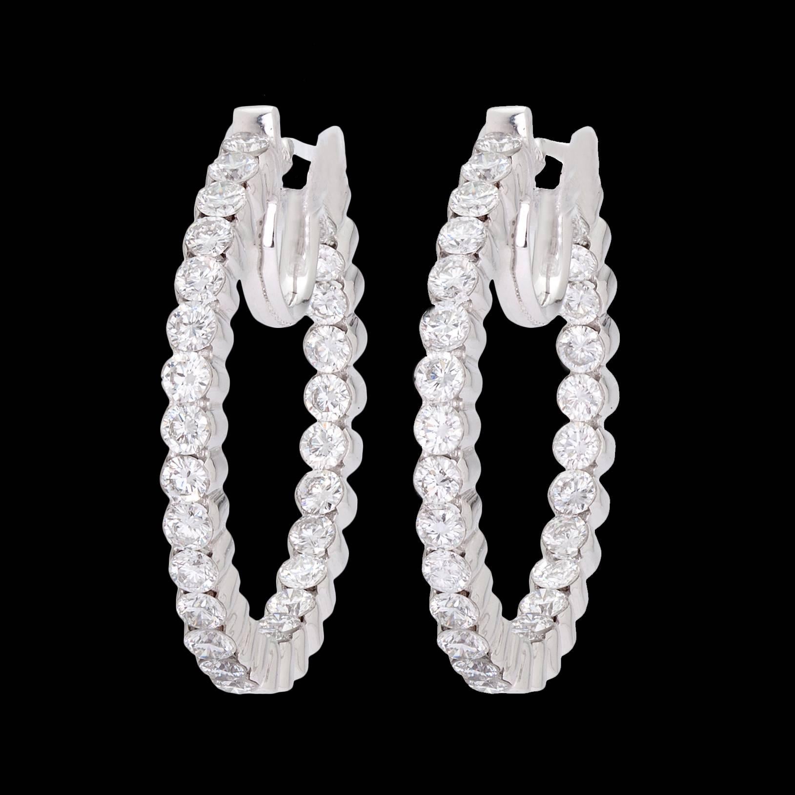 14k white gold hoop earrings with 60 round brilliant-cut diamonds totaling approximately 3.10cttw. The hoops measure 3.0mm wide, 28.0mm in diameter, and weigh 8.8 grams.  A sparkling staple for a big look.