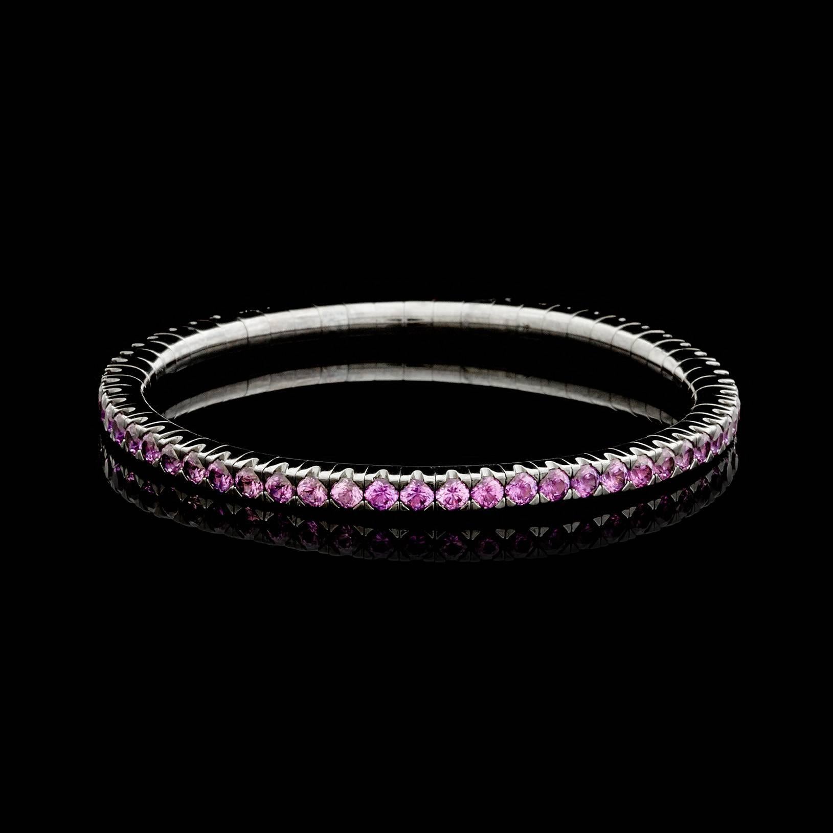 Mattia Cielo 'Universo Expandable Bracelet' features 7.24 carats of round brilliant-cut pink sapphires set in 18k blackened gold. The bangle is designed as an expandable, metal-spring line bracelet, fits a 6 inch wrist, and measures 3.7mm wide.