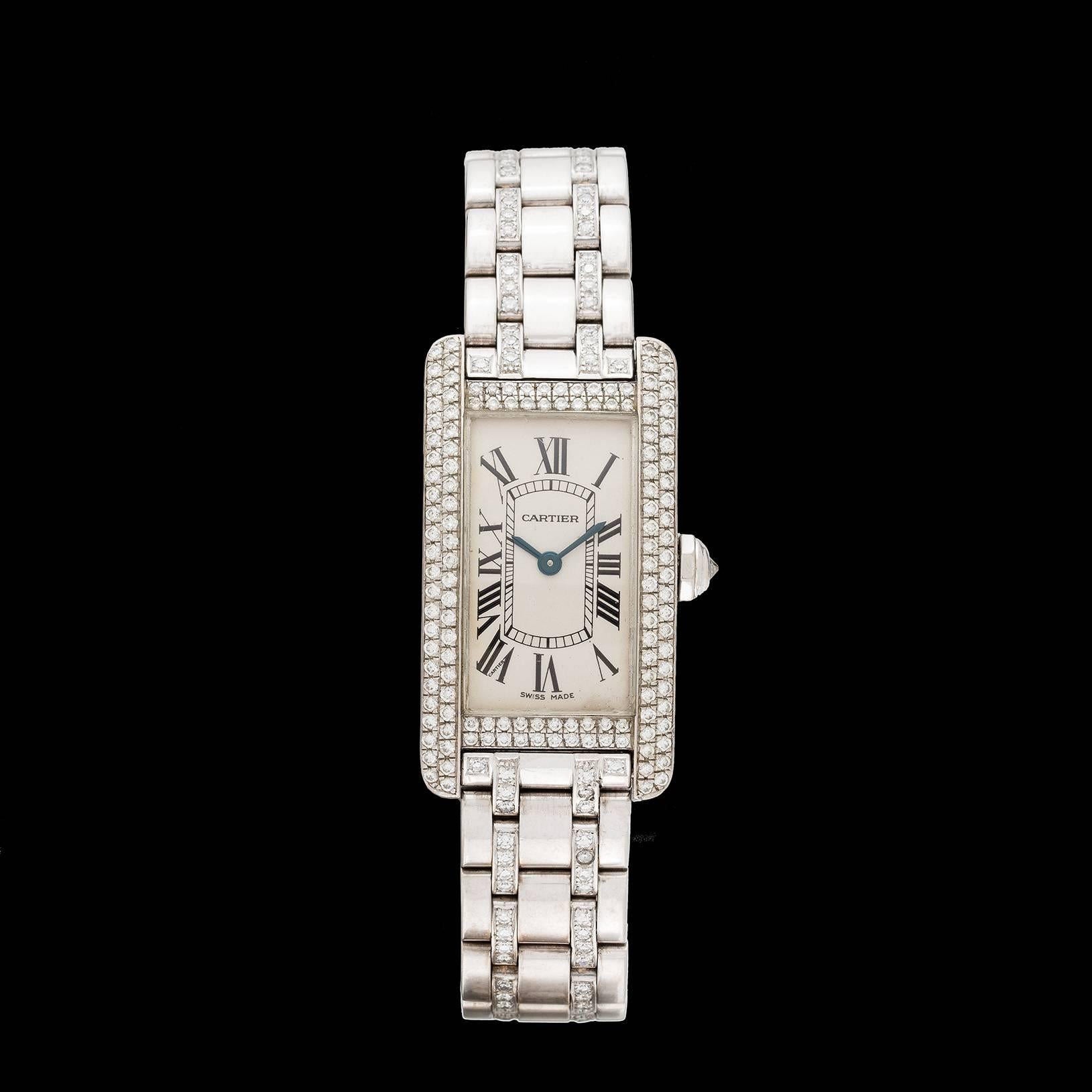 Cartier Tank Américaine automatic watch in 18k white gold with diamond bezel, diamond-set bracelet and deployant clasp. Estimated total diamond weight is 3.26 carats. The case measures 19 x 34mm, and fits a 7 inch wrist. A opulent version of a