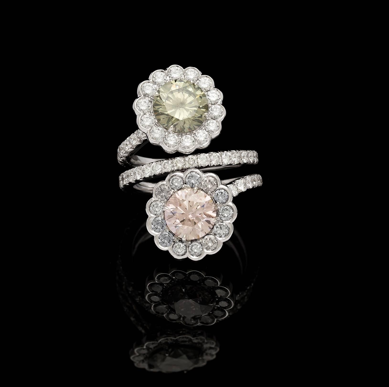 The 18k white gold flower bypass ring features a GIA 1.93-carat fancy dark greenish-gray round brilliant-cut diamond and a GIA 1.70-carat fancy brown-pink round brilliant-cut diamond. Each stone is surrounded by blue-gray and near colorless round