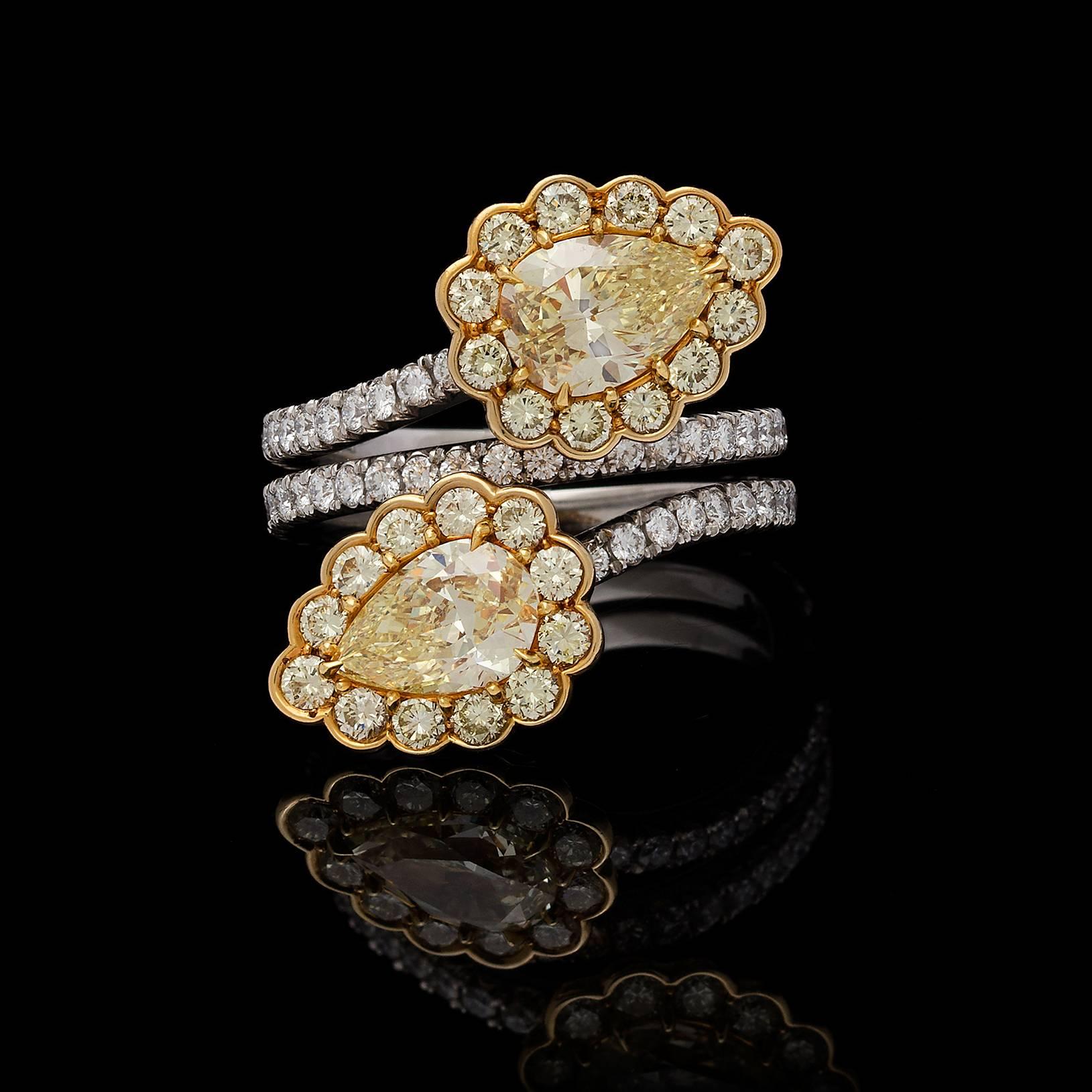 The platinum and 18k yellow gold ring features two GIA fancy light yellow pear-shaped diamonds, weighing 1.15 and 1.01 carats, each framed by yellow round brilliant-cut diamonds, with near colorless round brilliant-cut diamond-set mount. Total