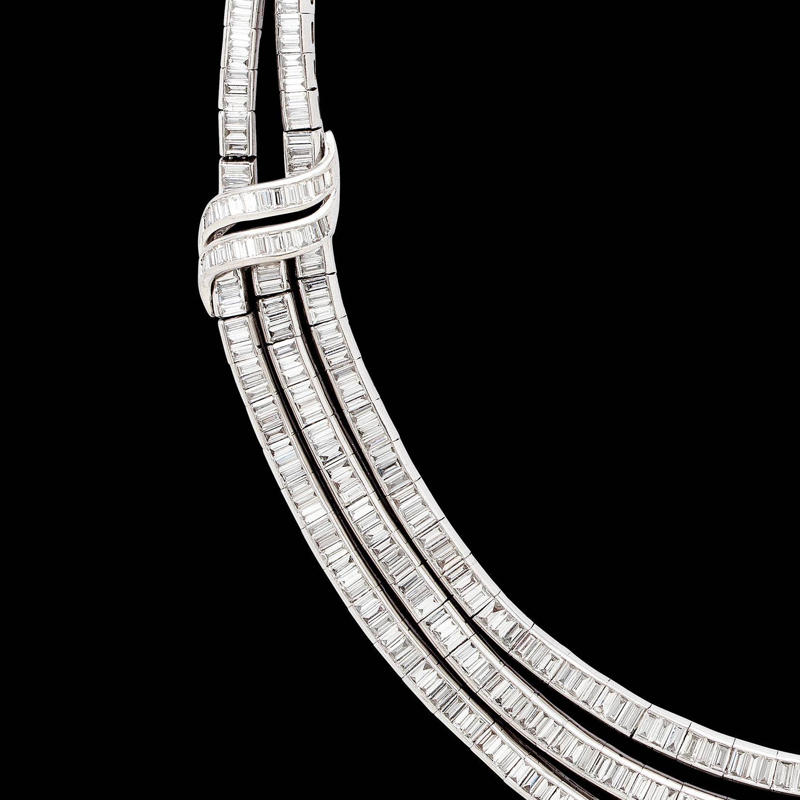 From a classic 1950's design, the Sophia D. platinum triple-swag diamond necklace is set throughout with baguette-cut diamonds, weighing in total an estimated 22.0 carats. The necklace measures 16 inches and weighs 90.0 grams. Cool elegance at it's