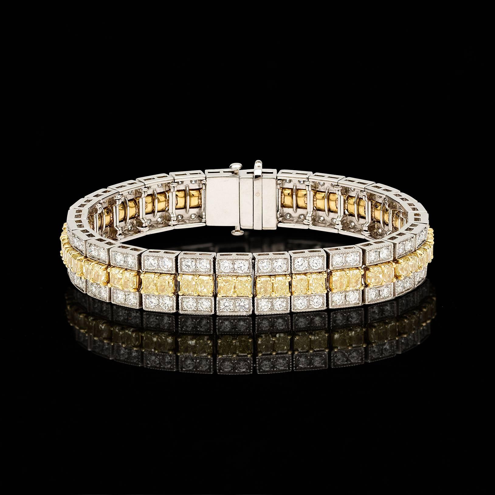 56 Fine Fancy Yellow Diamonds surrounded by 112 Fine White Diamonds come together to create a one-of-a-kind custom Platinum bracelet that is sure to turn heads. The total weight of the Fancy Yellow Diamonds is approximately 15.22 carats while the