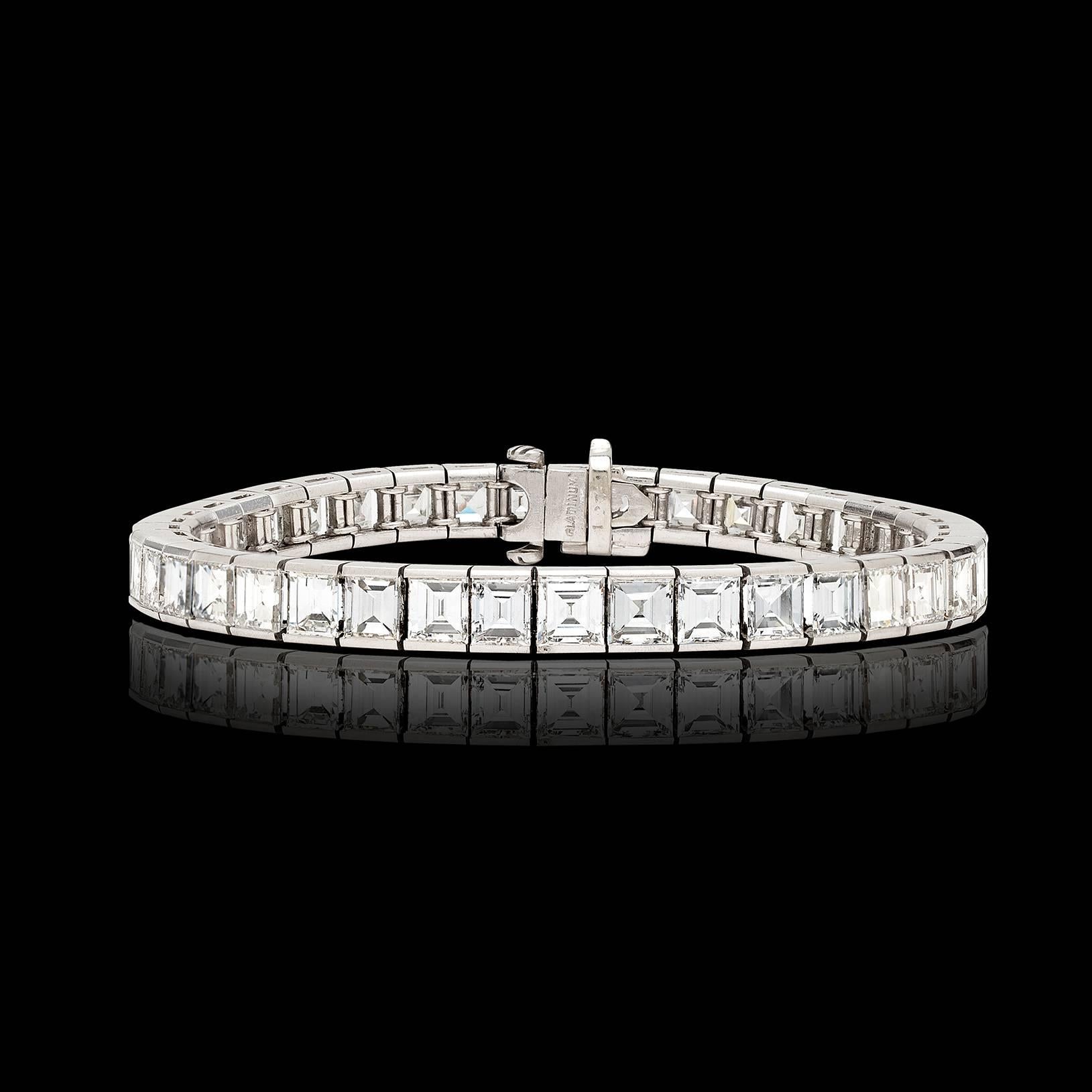 41 gorgeous emerald cut diamonds, weighing in total approximately 20.50 carats, make up this elegant platinum line bracelet. This classic stunner measures 7 inches in length and weighs 40.9 grams. This exceptional take on an enduring design is a