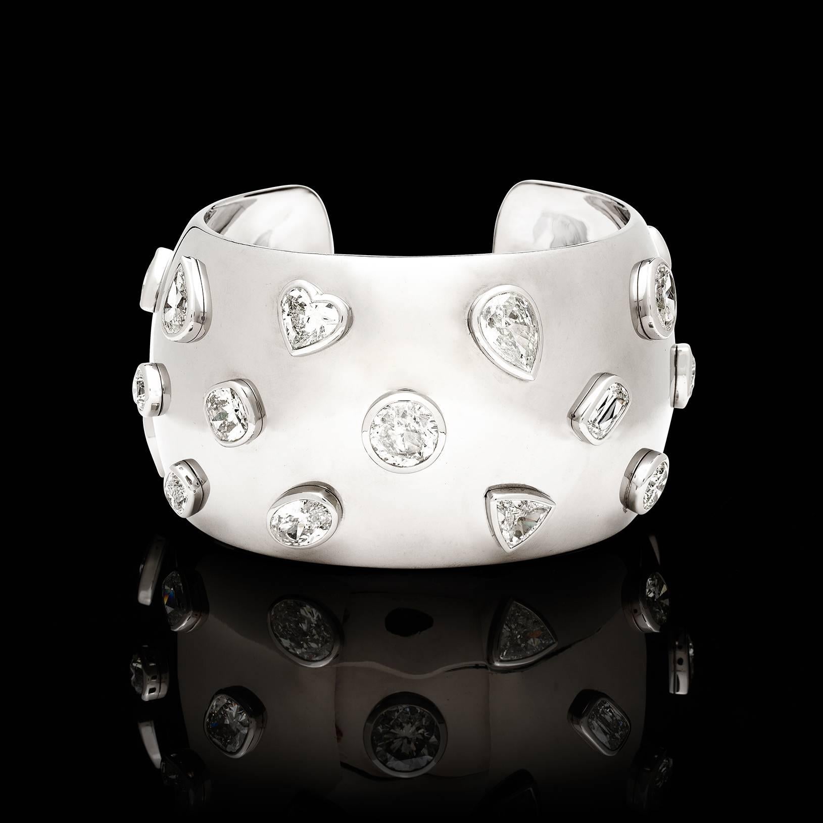 This wide, palladium cuff bracelet adorned with 20 various bezel-set fancy and round brilliant-cut diamonds, weighing in total 27.93 carats, is a one-of-a-kind showstopper! The bracelet is 1 5/8 inches wide, and weighs 134.5 grams. Accompanied by 11