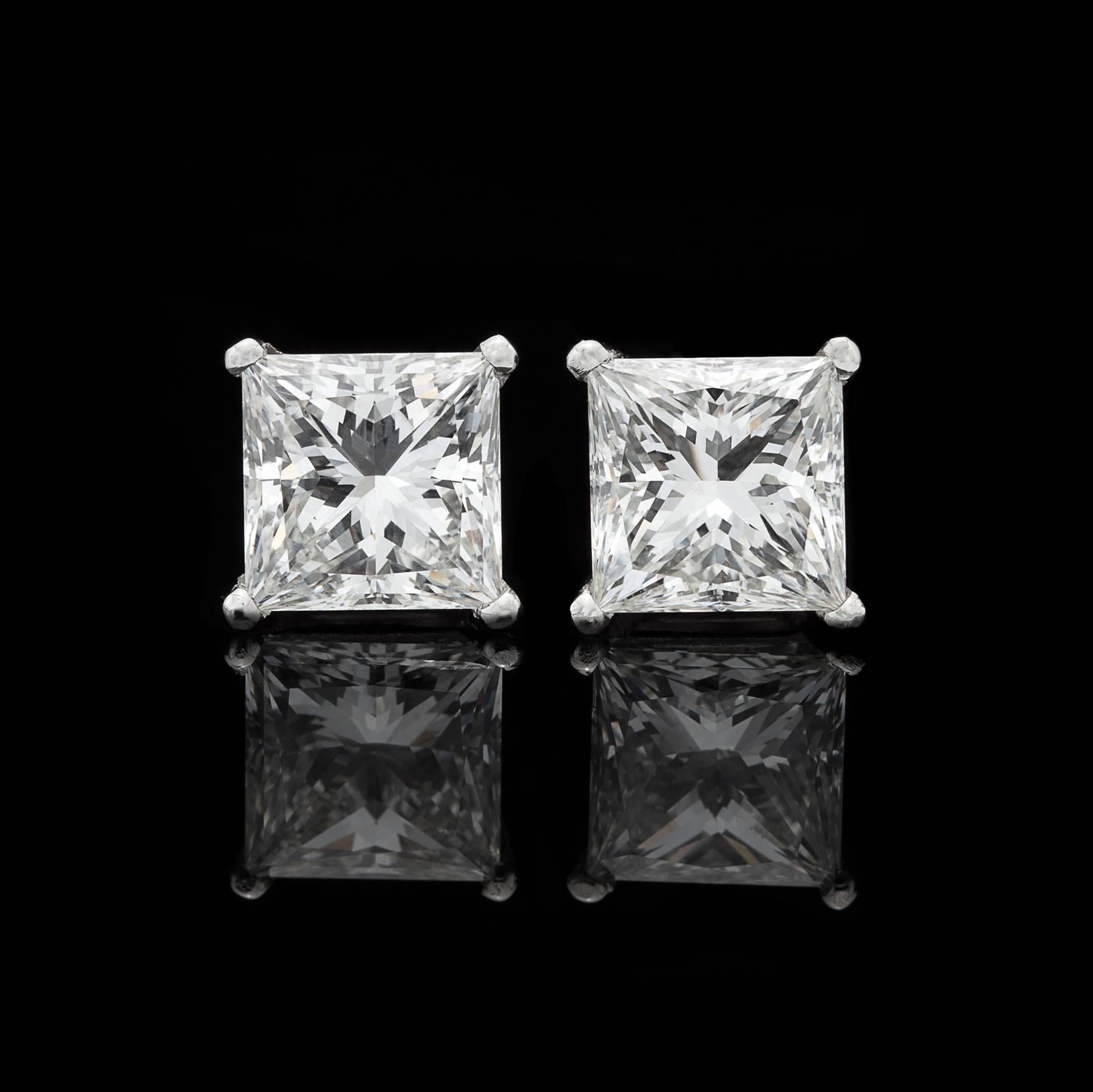 A truly exceptional pair of diamond earrings featuring two beautifully matched Princess Cuts for a total combined weight of 4.20 carats. Accompanied by GIA reports grading the stones as H/VS1 and H/SI1, these gorgeous diamonds make for a stunning