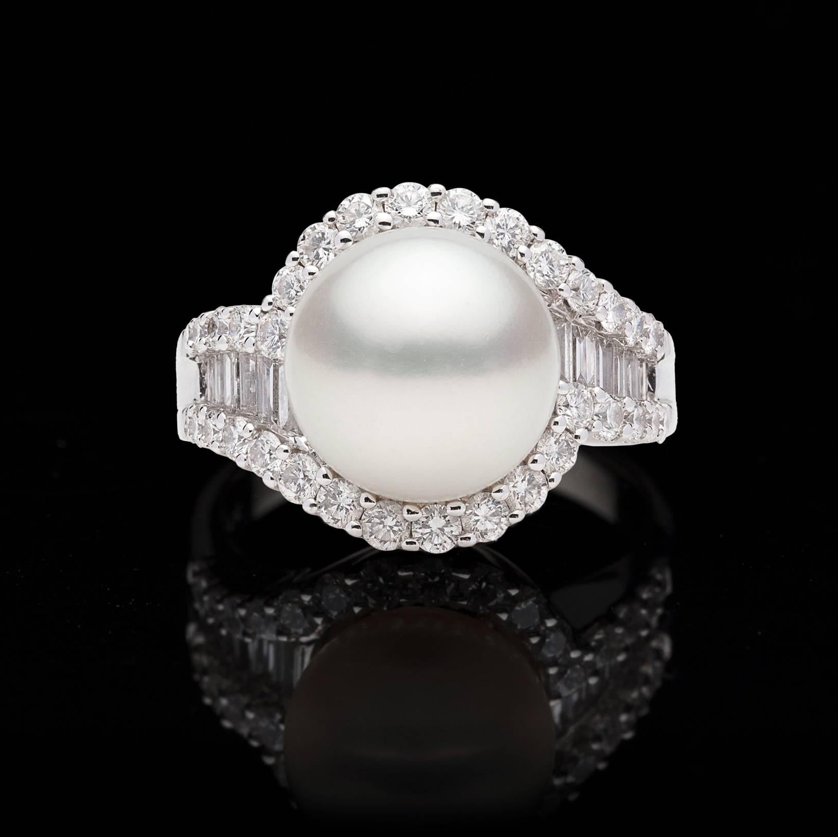 A wonderful statement piece that epitomizes beauty. One high luster pearl that measures 11.3mm is surrounded by a carat of fine white round and baguette cut diamonds. Set in 18kt white gold, this elegant ring weighs 9.5 grams. Currently a size 8.0,