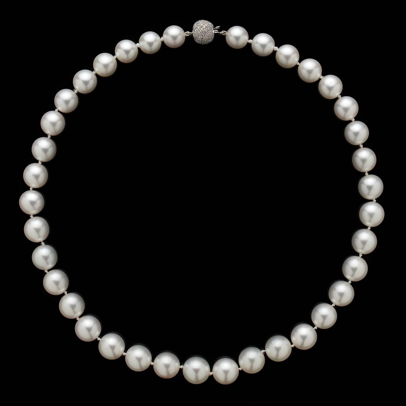 High luster, perfect roundness, evenness of color and lack of pitting make for this remarkable strand of South Sea Pearls on a fine Diamond Ball Clasp. Measuring 10.1-12.3mm, these eye catching pearls radiate beauty and are accented with over a