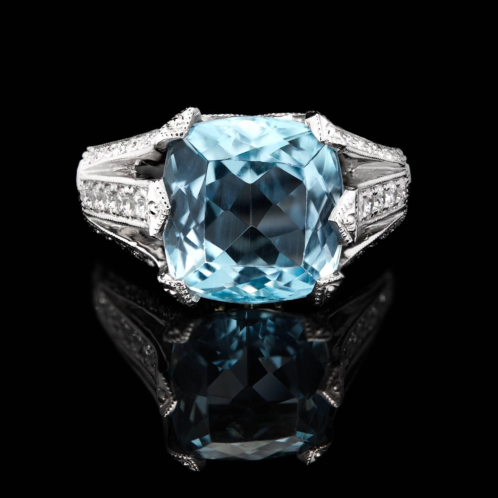 Purchased from the estate of a collector from California's central coast, this gorgeous Platinum ring features one 4.55 carat faceted Aquamarine set among 40 sparkling round cut diamonds for approximately 0.41cttw. The split shank ring is currently