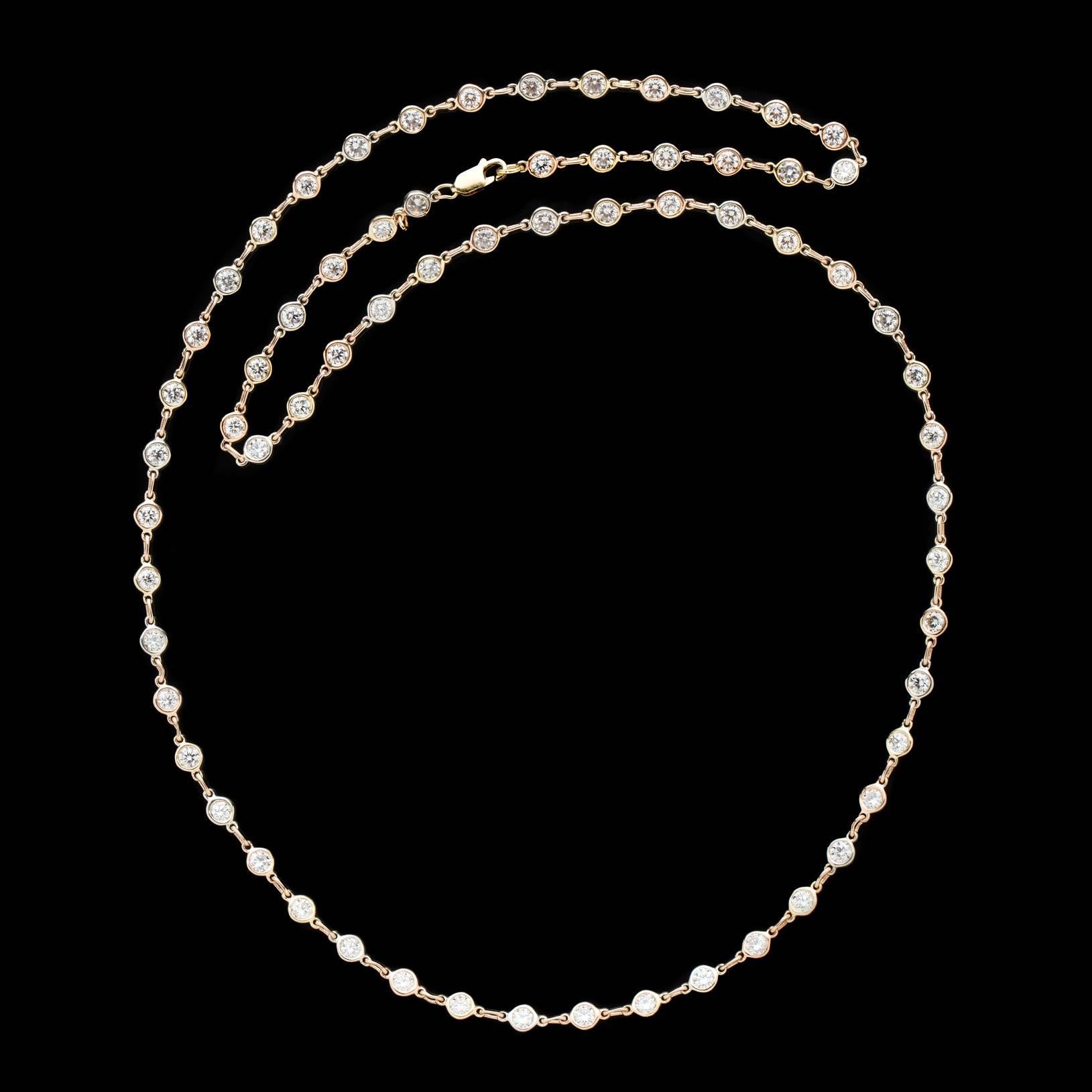Incredible diamonds meet gorgeous craftsmanship in this exquisite Diamond Line Necklace. Featuring 66 fine diamonds averaging G/VS for almost 20 carats delicately bezel set in alternating rose, yellow and white gold, this beautiful statement piece