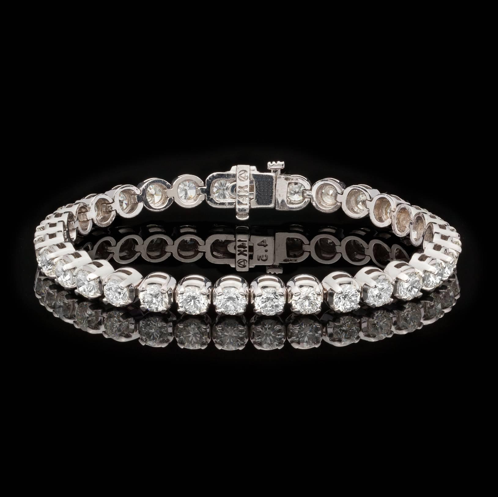 A truly beautiful bracelet that is sure to get plenty of wear. This 14 karat white gold sparkler features 34 fine white diamonds (average H-I color, VS2-SI1 clarity) for 10.66 carats total weight expertly set in four prong settings positioned for