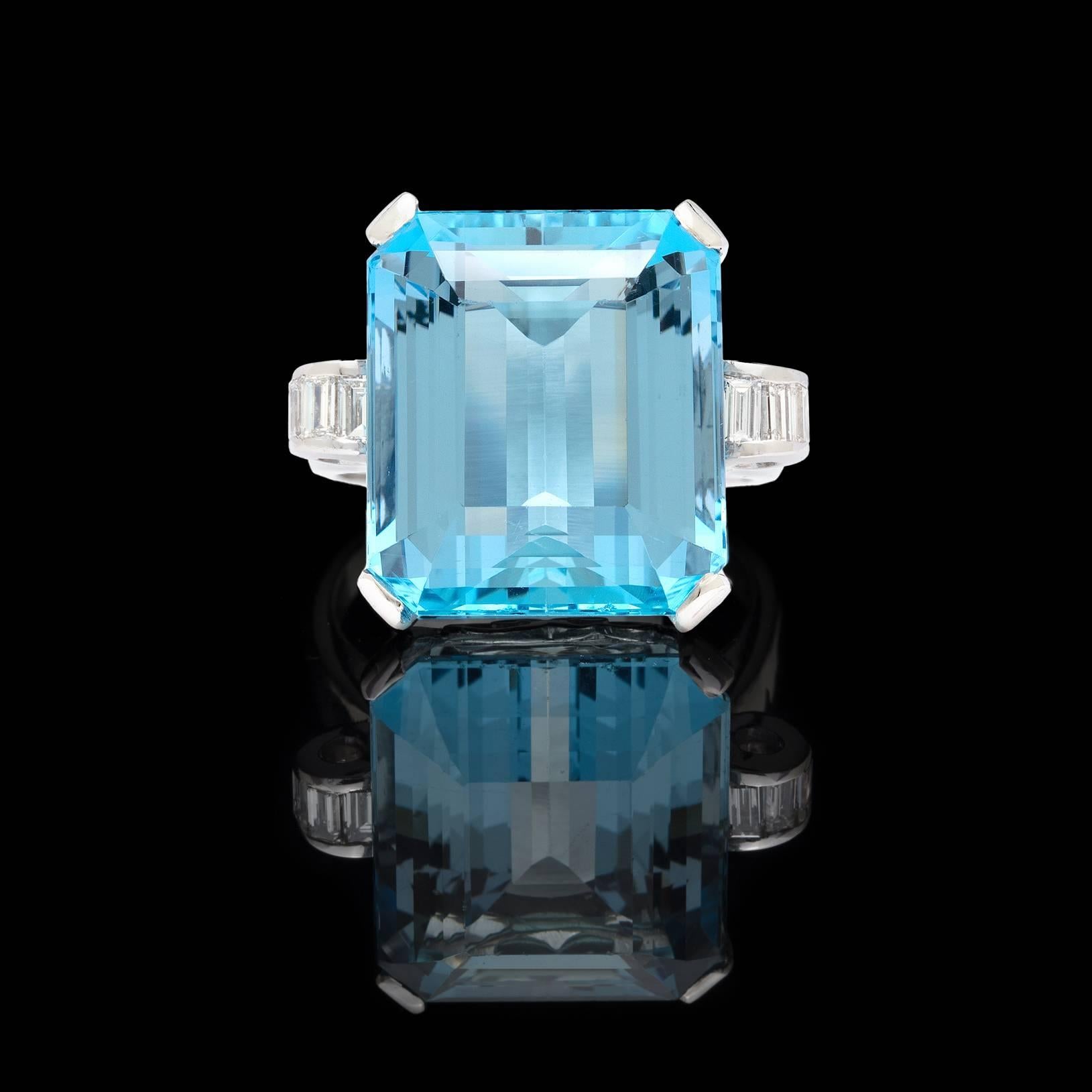 There's blue and then there's BLUE! This gorgeous 1930-40's estate ring features a 16 carat step cut aquamarine that exemplifies the color one looks for when searching for the ideal aqua. Elegantly set between eight clean/white baguette cut diamonds
