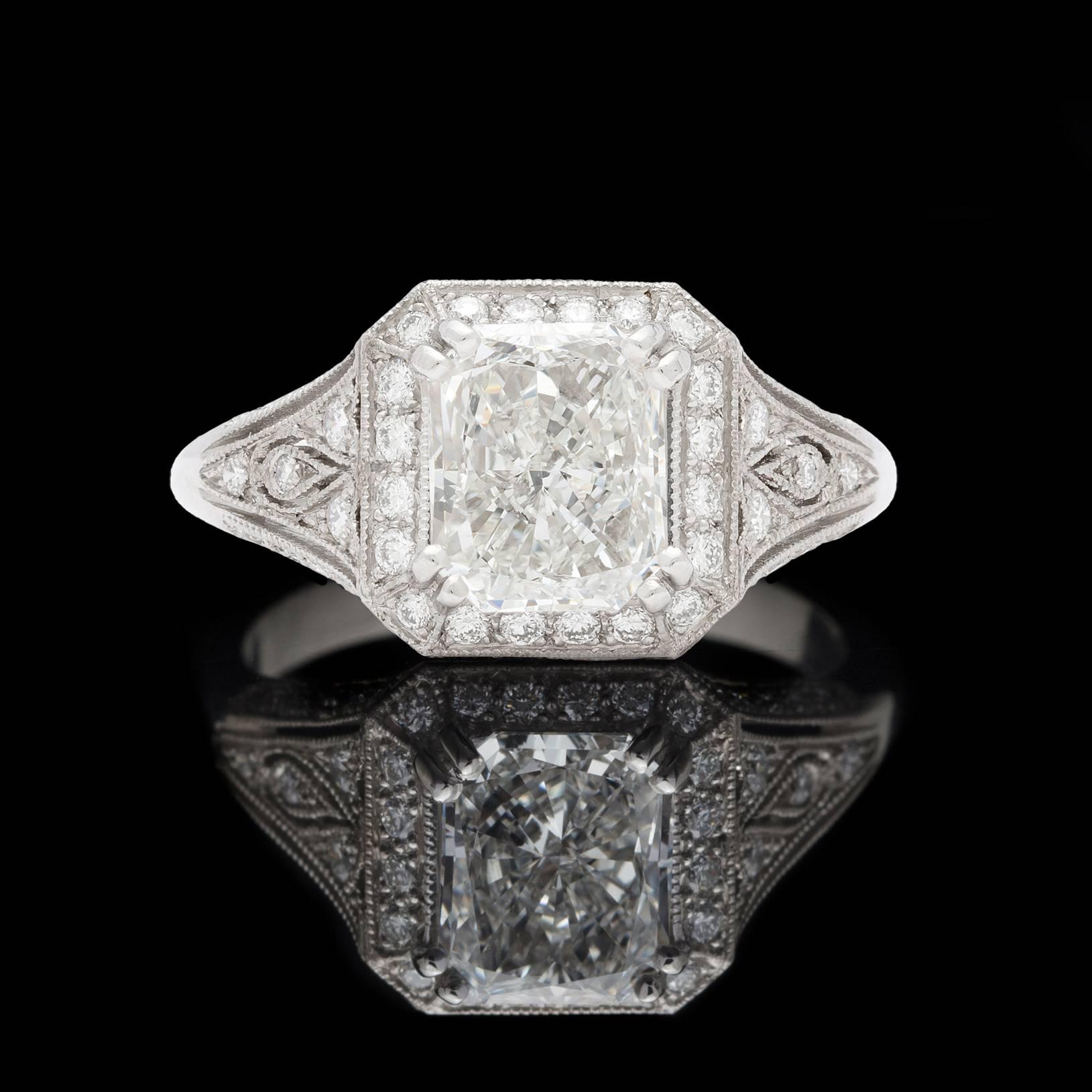 Phenomenal design and craftsmanship meet one very special diamond in this Platinum ring by French designer Sebastien Barier. The 1.71 carat Radiant Cut center stone is a GIA G/VS1 with tremendous sparkle and fire, surrounded by over half a carat of