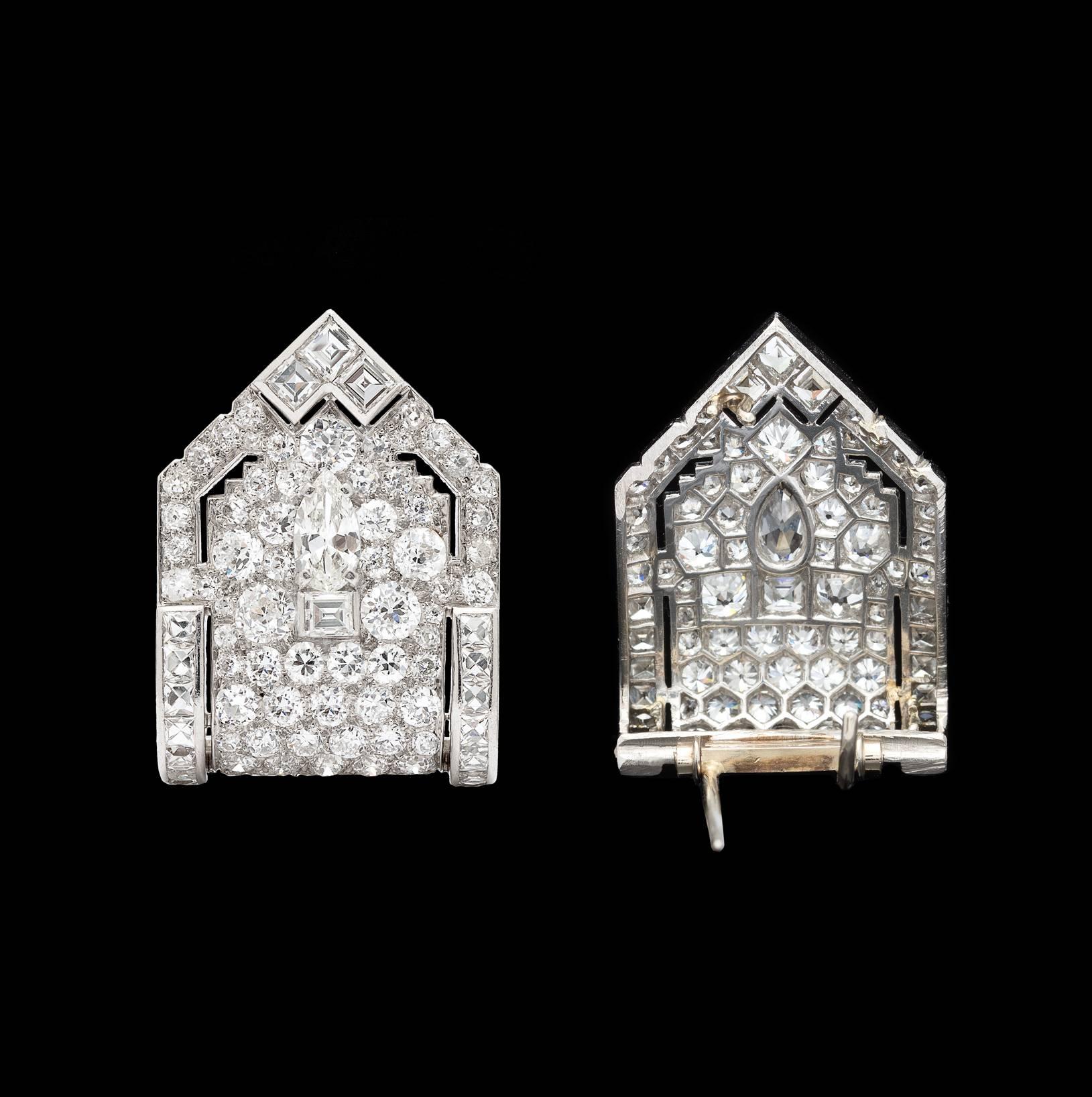 A gorgeous pair of platinum art deco shield-shaped dress clips, set with 160 European, pear, old mine, French, and square-cut diamonds. The estimated total diamond weight is 10.40cts., with an overall quality of G-H-I color and VS-SI clarity. They