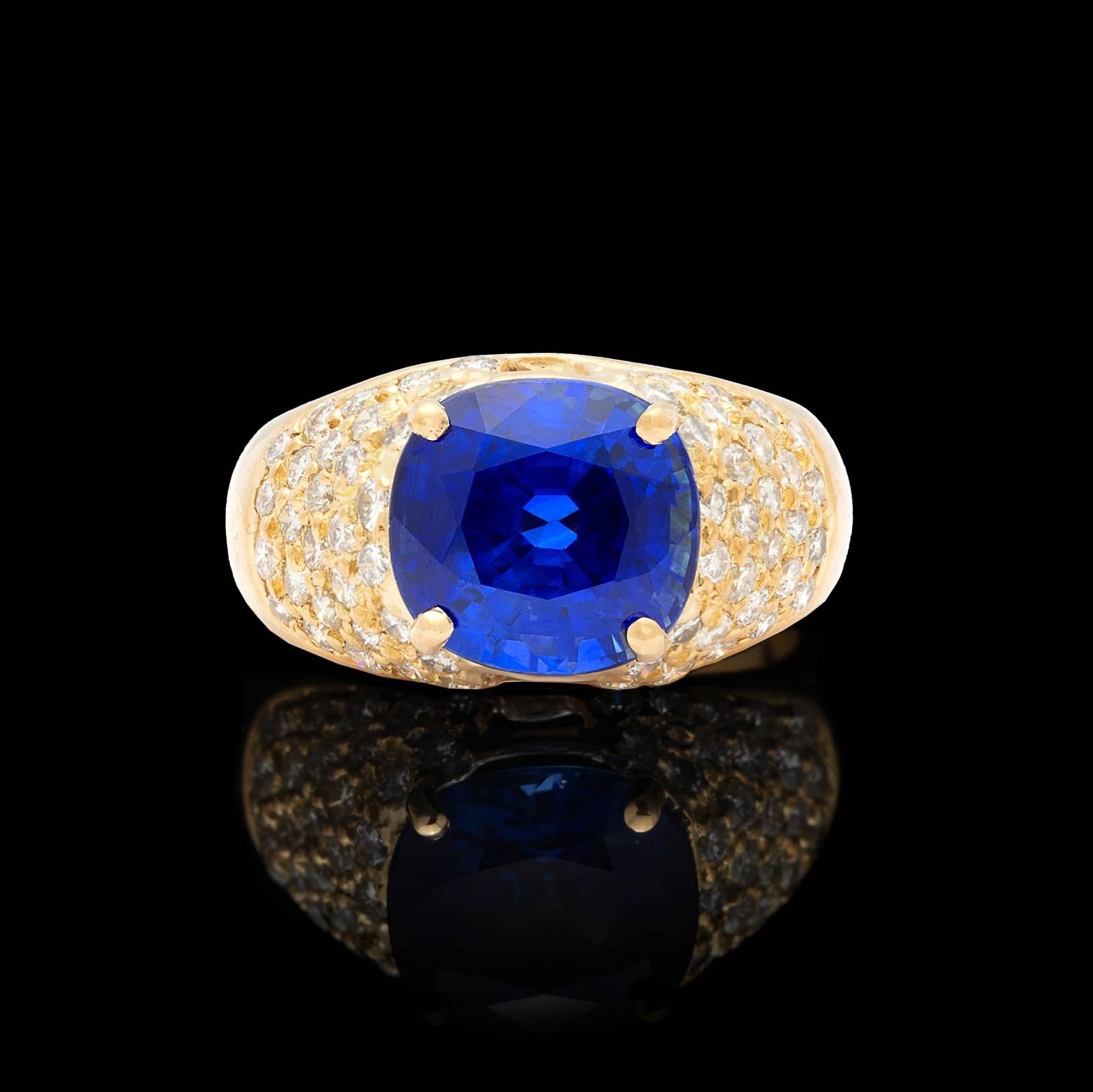 Eye-catching 5.80-ct oval-cut sapphire set on the horizontal, well saturated with deep azure color, surrounded by pave-set round brilliant-cut diamonds, weighing approximately 1.20cts.  The ring is currently a size 7 1/4, and can easily be sized up