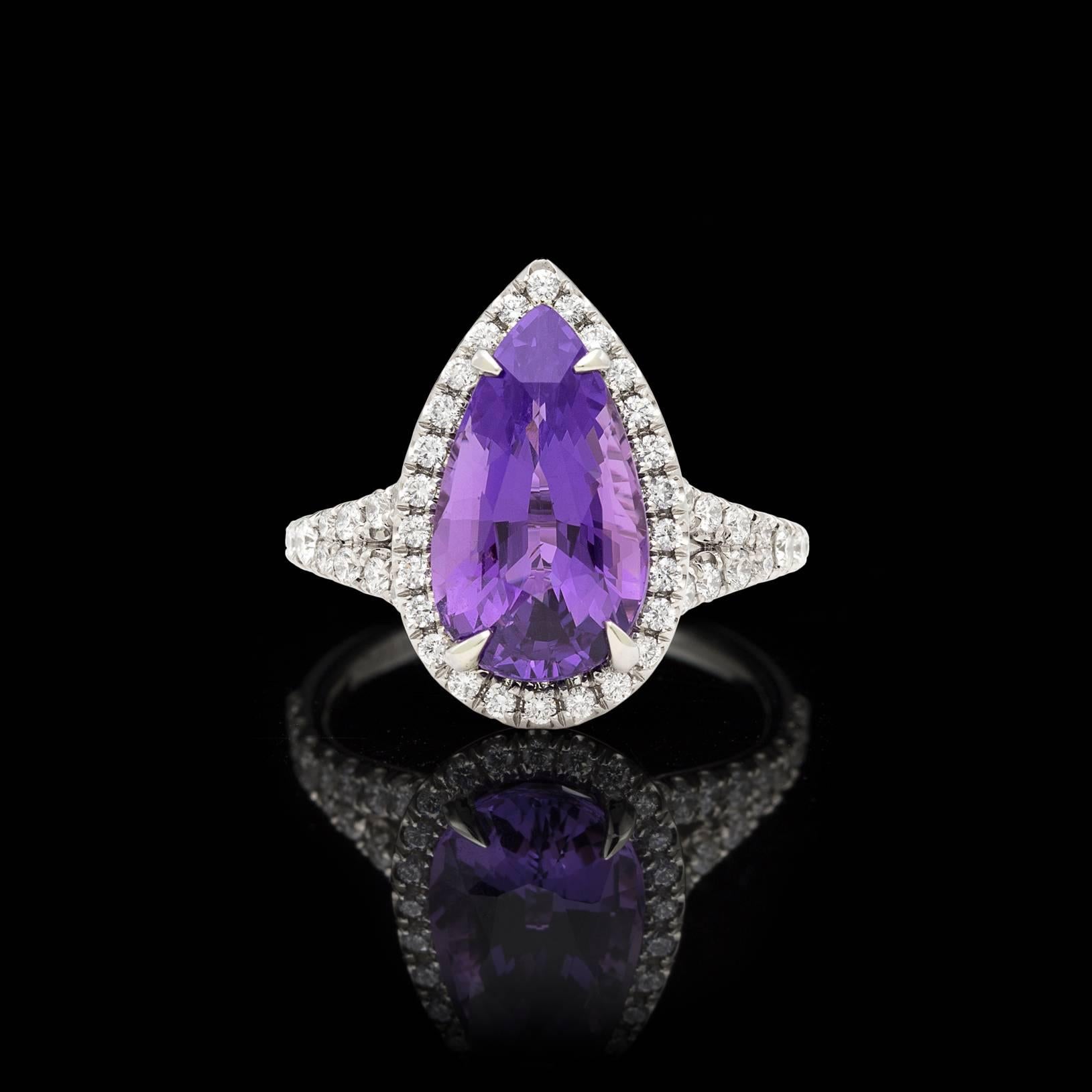 A true one of a kind! This custom split shank platinum ring features a spectacular GIA graded Unheated Natural Purple 5.04 carat Pear Shaped Sapphire, surrounded by a halo of sparkling white diamonds. This rare, unheated sapphire has remarkable