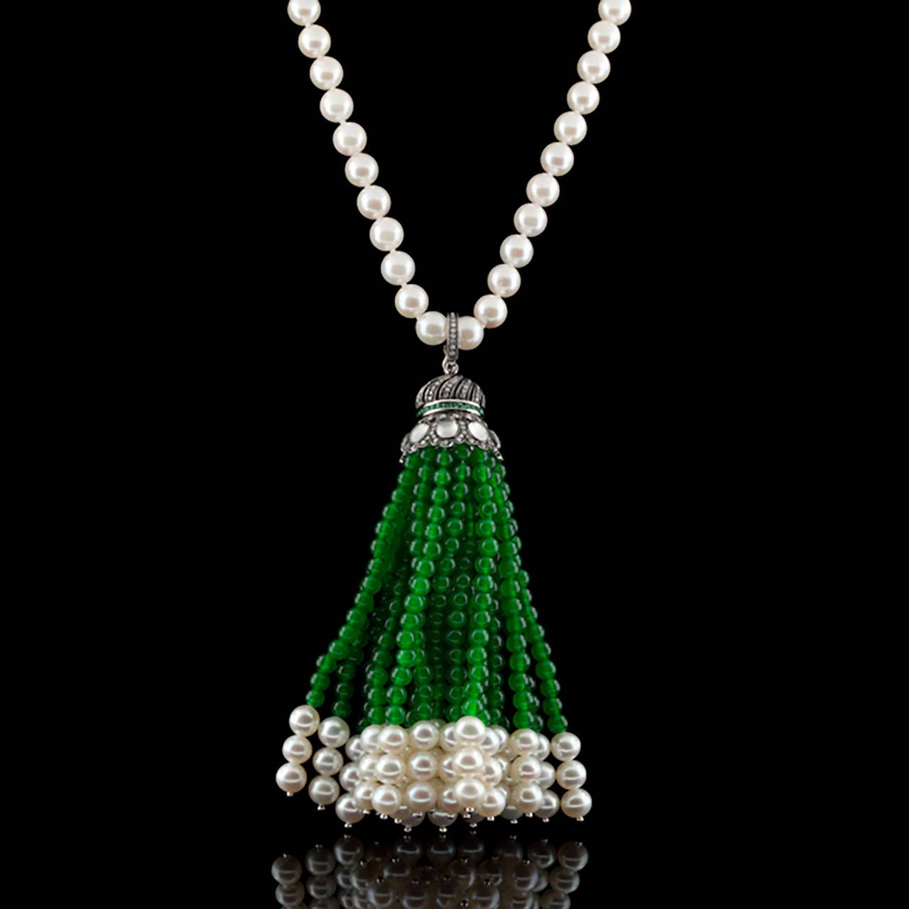 Sautoir 18Kt White Gold Necklace of Cultured Pearls, Moonstones, Green Colored Stones and Diamonds. The tassel suspends 4.25 inches from a 17 inch pearl necklace with 14Kt yellow gold clasp.