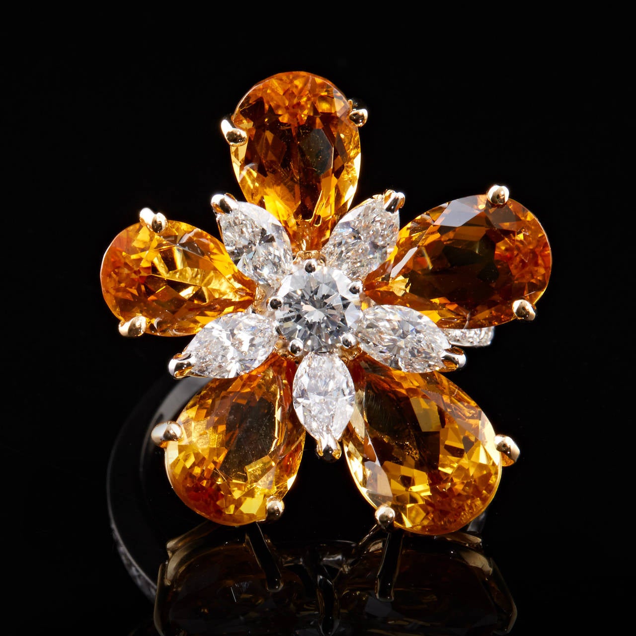 Luca Carati 18Kt white gold flower design ring featuring 5 pear shape citrine flower petals set in yellow gold. The center of the flower is a round brilliant diamond surrounded by 5 marquise cut diamonds set in white gold. The 1.71 carat total