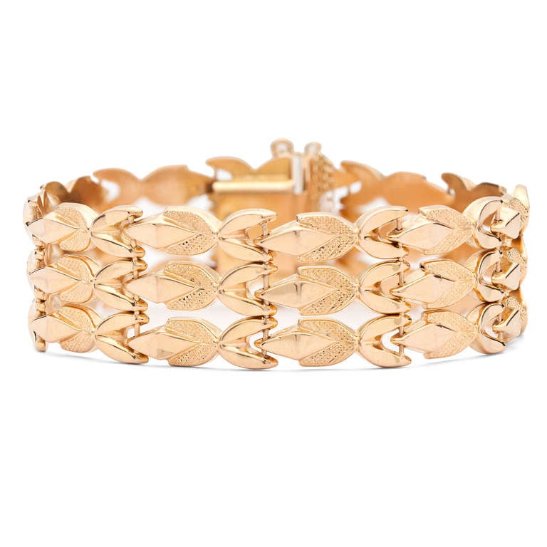 Retro 18Kt Yellow Gold Bracelet Delicately Drapes on the Wrist. The bracelet is 18mm in width and a size 7.5, weighing 25 grams.