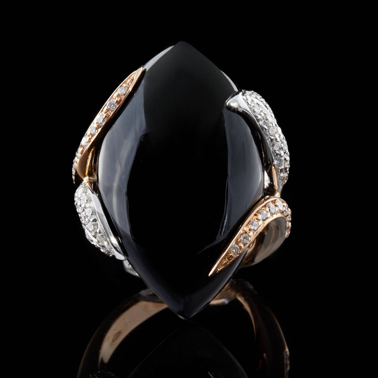 Luca Carati 18Kt Rose Gold Ring features a bold 29.5 carat Onyx polished & cut in a Navette shape. Detailed on the 4 leaf & vine design prongs are round brilliant diamonds totaling 0.52 carats with F-G color & VS clarity. The measurements of the