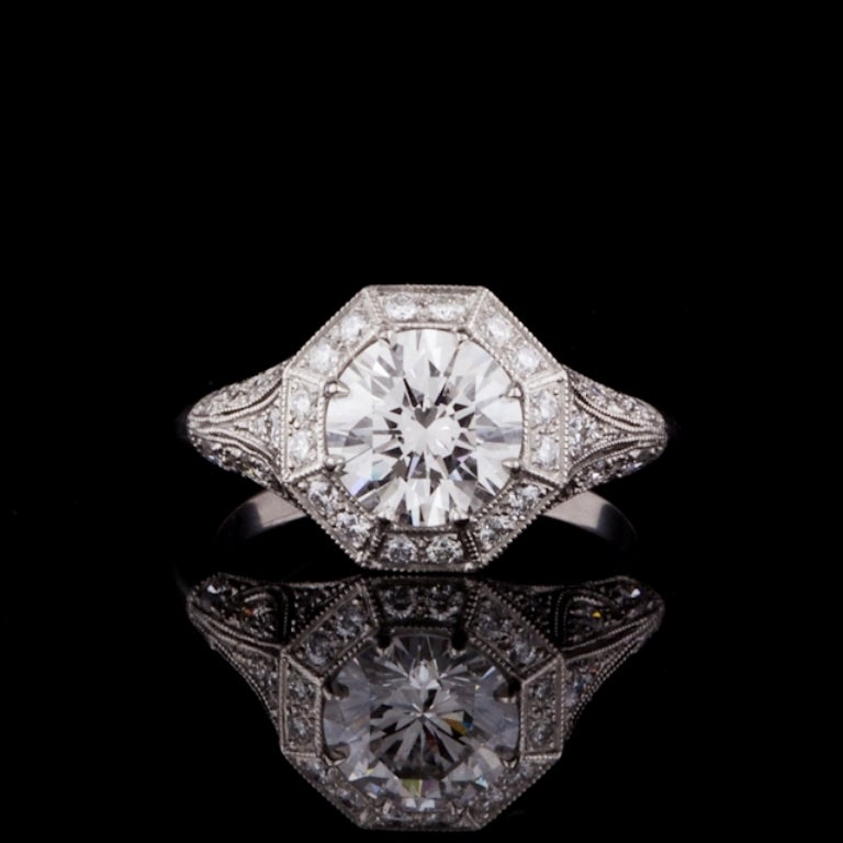 Custom made Sebastien Barier ring featuring a 1.51ct (G color, SI1 Clarity) Round Brilliant Cut diamond, complete with GIA Grading Report 8681996 for the center stone, accented by an octagonal pave diamond border and diamond platinum ring, mounted