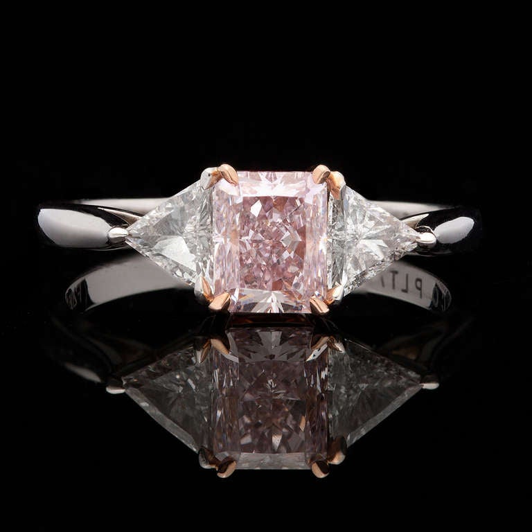 Extremely Rare GIA Natural Fancy Purplish Pink Diamond for 1.01cts in JE Caldwell Platinum Setting with Rose Gold Detail.  The color is evenly distributed through this breathtaking Rectangular Modified Brilliant Cut VS1 Diamond and the polish is