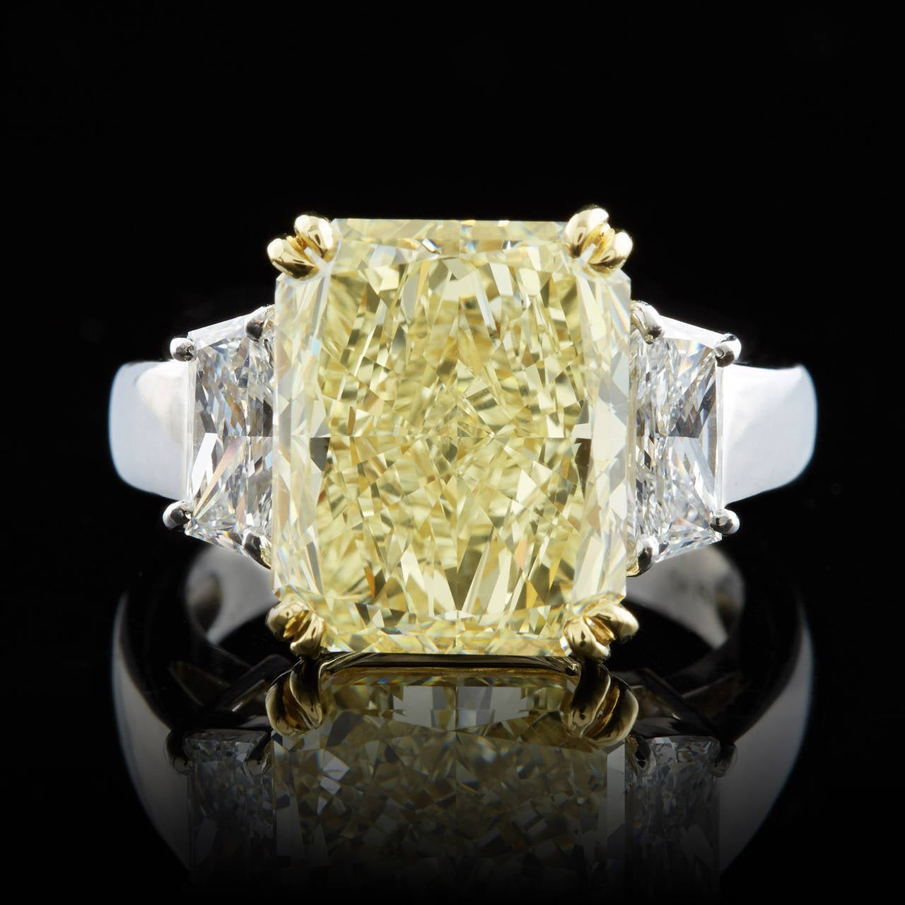 Gorgeous Platinum Three-Stone Diamond Ring Features a Center 8.00-ct Fancy Light Yellow Radiant Cut Diamond with VS2 Clarity, Set in an 18Kt Yellow Gold 4-Prong Setting. Flanked on the sides are 2 trapezoid cut diamonds totaling 1.72 carats with F