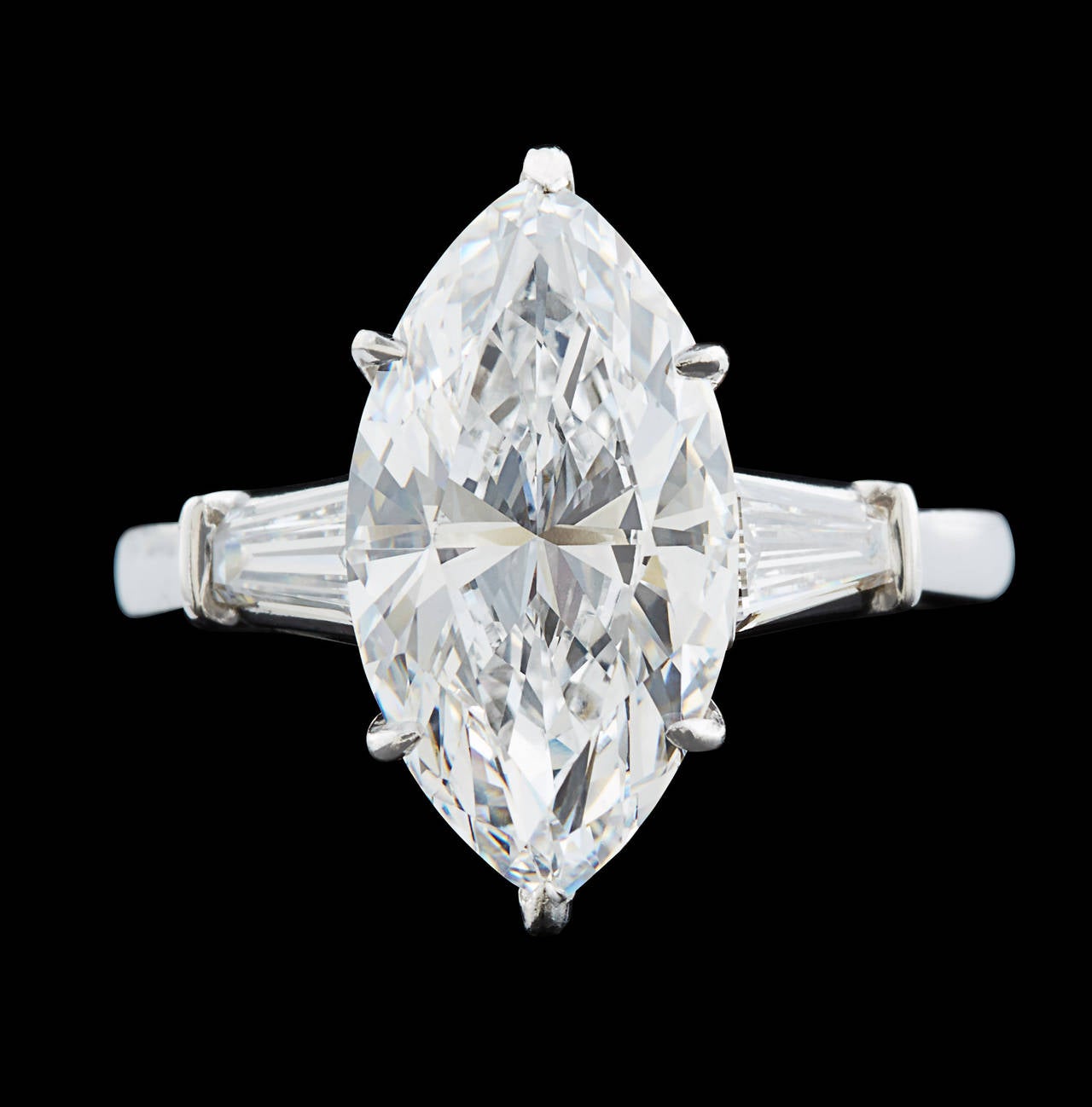 Spectacular Platinum 3-Stone Ring Featuring a Crystal Clear 5.02 Carat D Flawless Marquise Cut Diamond. Flanked on each side are tapered baguette diamonds weighing approximately 0.50 carat total weight. The ring is a sizable 8.25 and weighs 8.2