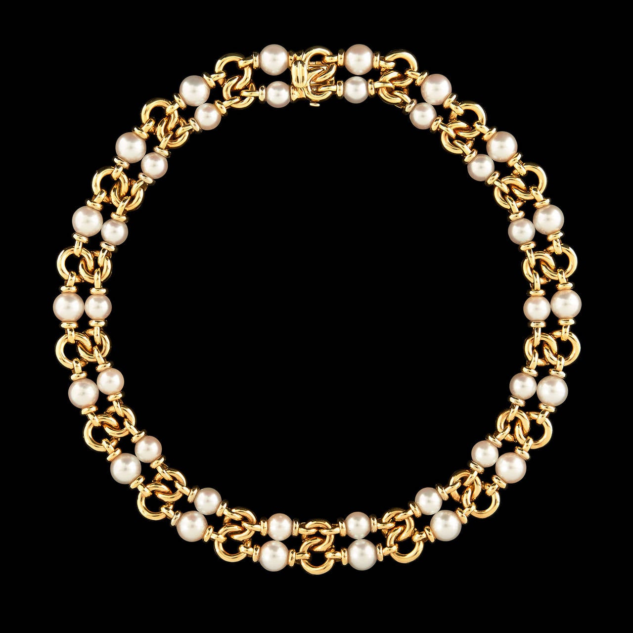 Bulgari Necklace Featuring Japanese Akoya Pearls in 18Kt Yellow Gold. The pearls range in size, the top row 8mm and the bottom row 7mm. The necklace is 15 inches long and a half inch wide and weighs 113.1 grams.