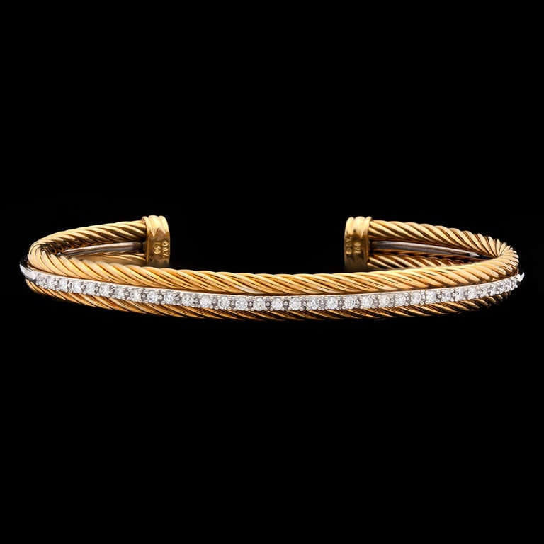 Estate Bracelet by David Yurman Features 33 Round Diamonds, for approximately 0.50ct, Set in 18Kt White Gold with 18Kt Yellow Gold Signature Rope Detail on Either Side.  The bracelet is a size 6.5 and totals 18.3 grams.