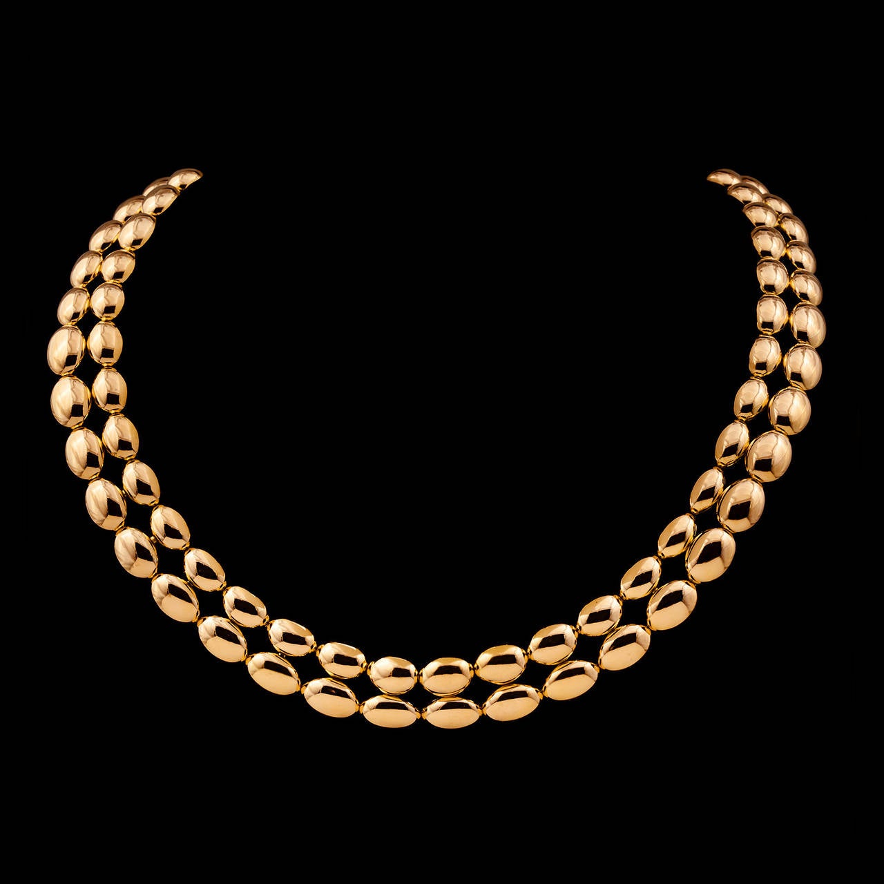 Chaumet 18Kt Yellow Gold Necklace Features 2 Rows of High Polish Yellow Gold Domed Ovals in a Simple and Powerful Design. The necklace measures 16.5 inches long and 19mm wide. This piece totals 122.5 grams.