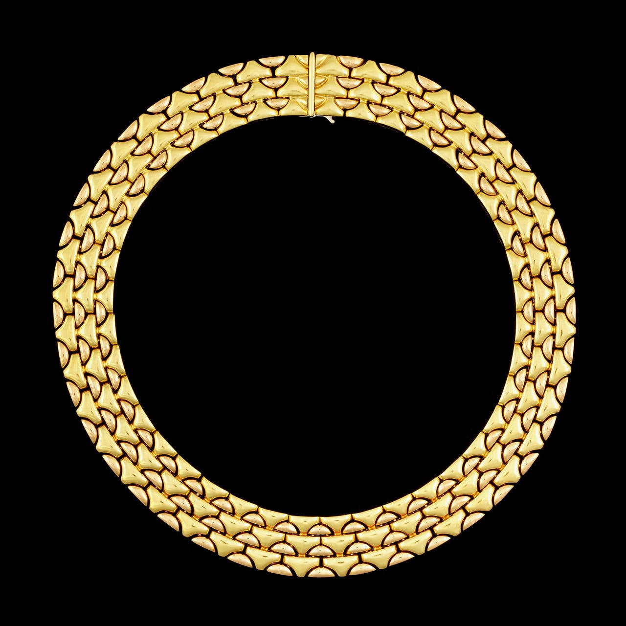 Bulgari Necklace Features Softly Curved Links of 18Kt Yellow and Rose Gold. The necklace measures 16 inches long and 17mm wide. This piece totals 188.9 grams.
