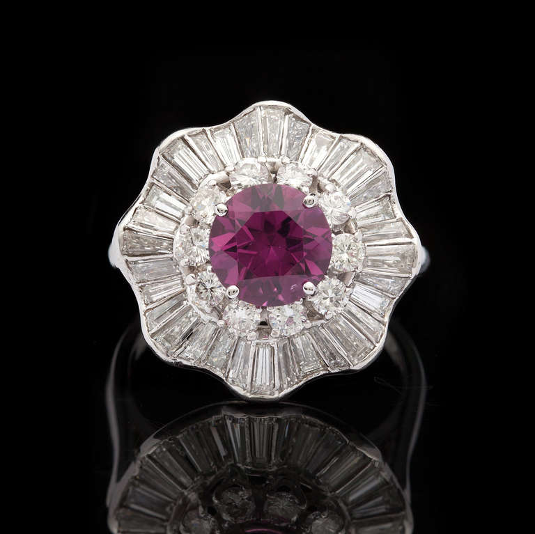 Platinum Ring Featuring One Modified Brilliant Cut Reddish Purple Garnet for 2.31cts with halo of 43 baguette and round brilliant diamonds for approximately 3.00cts.  The ring is a size 8.5 and weighs 11.5 grams.  GIA Report 6147630450 is included.