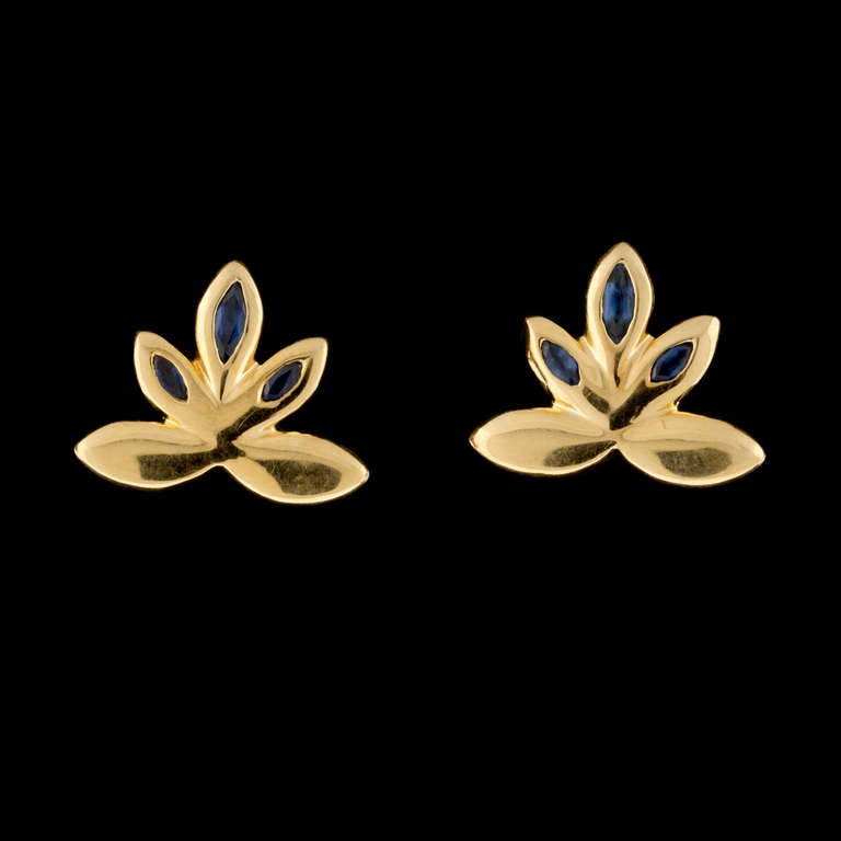 Chaumet 18Kt Yellow Gold Sapphire Clip Earrings feature 6 Marquise Cut Blue Sapphires for an approximate weight of 0.50cts.  The earrings measure 17mm x 20mm and that weigh 12.2 grams.