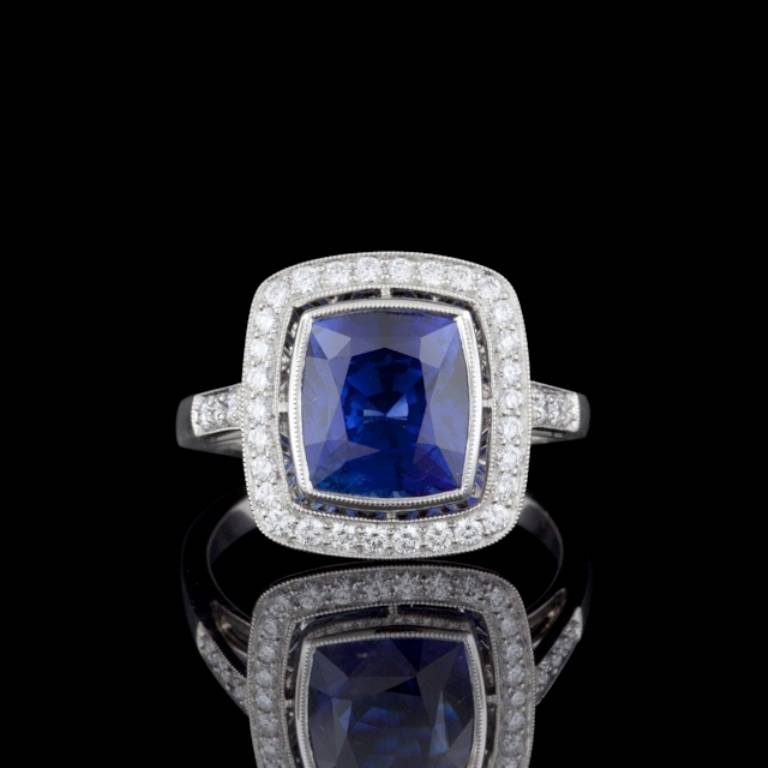 Gorgeous ring features one 4.42 carat Rectangular Cushion Cut Cornflower Blue Natural Sapphire with 36 Round Brilliant Cut Diamonds with a total approximate weight of 0.36 carats in a platinum setting. The total weight of the ring is 6 grams.