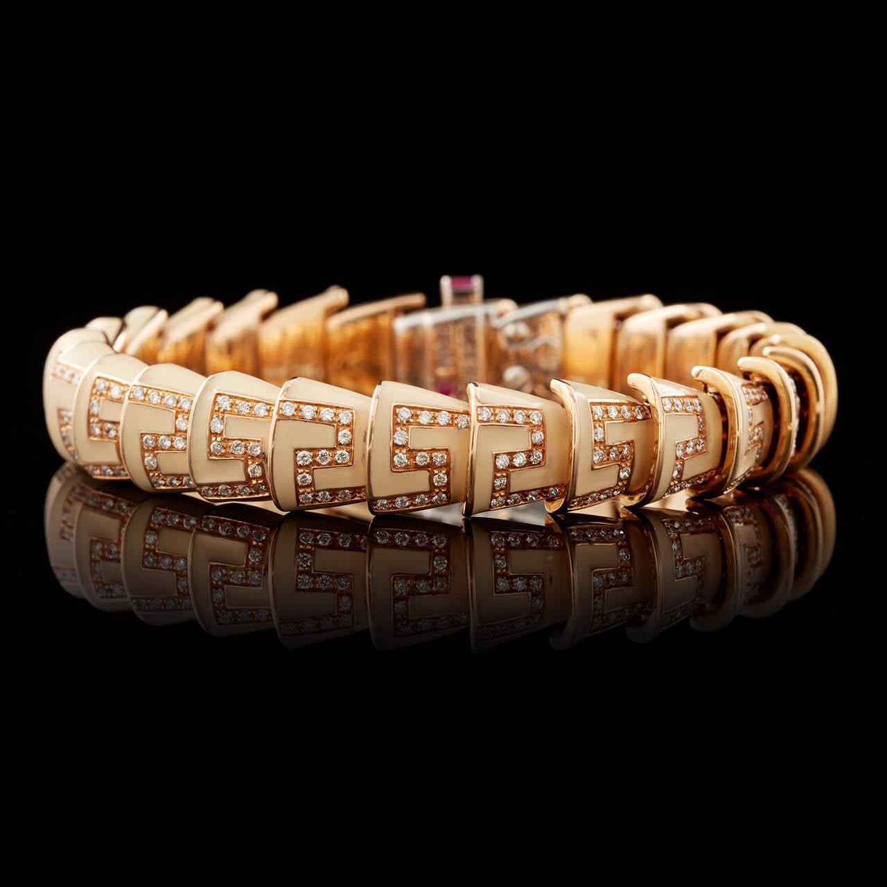 Roberto Coin Cobra design Cream color Enamel Bracelet accented with 1.76 carats of Round Brilliant Diamonds set in 18Kt Rose Gold. This bracelet measures 7″ L x 0.38″ W and weighs 49.5 grams total.