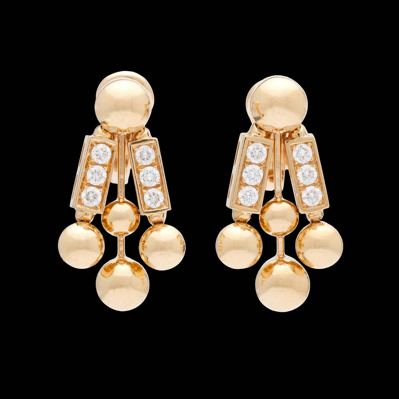 A Fantastic Pair of Bulgari Earrings in 18Kt Yellow Gold with 12 Round Brilliant Cut Fine Diamonds Totaling 0.60 Carat. The earrings measure approximately 1 inch long and weigh 19.3 grams together.
