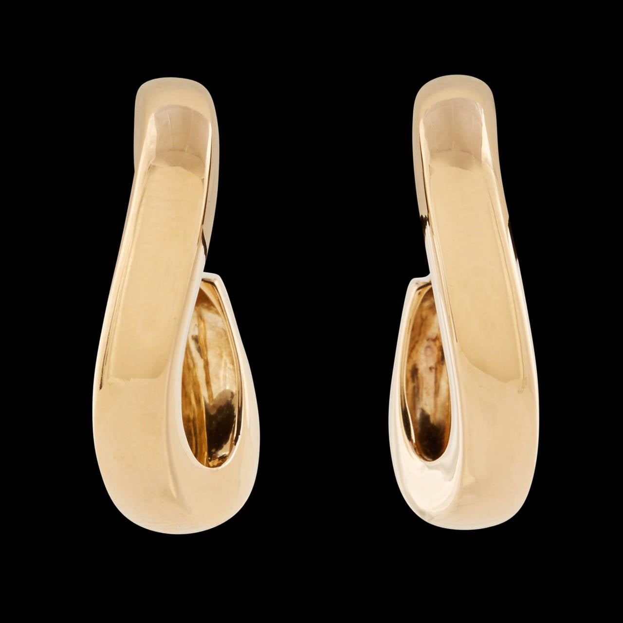 Chaumet Waltz Hoop Earrings in 18Kt Yellow Gold with Posts and Omega Backs. The hoops are 1 inch long and 5.5mm wide. The total weight of the pair is 17.4 grams. A Chaumet Certificate of Authenticity is included.