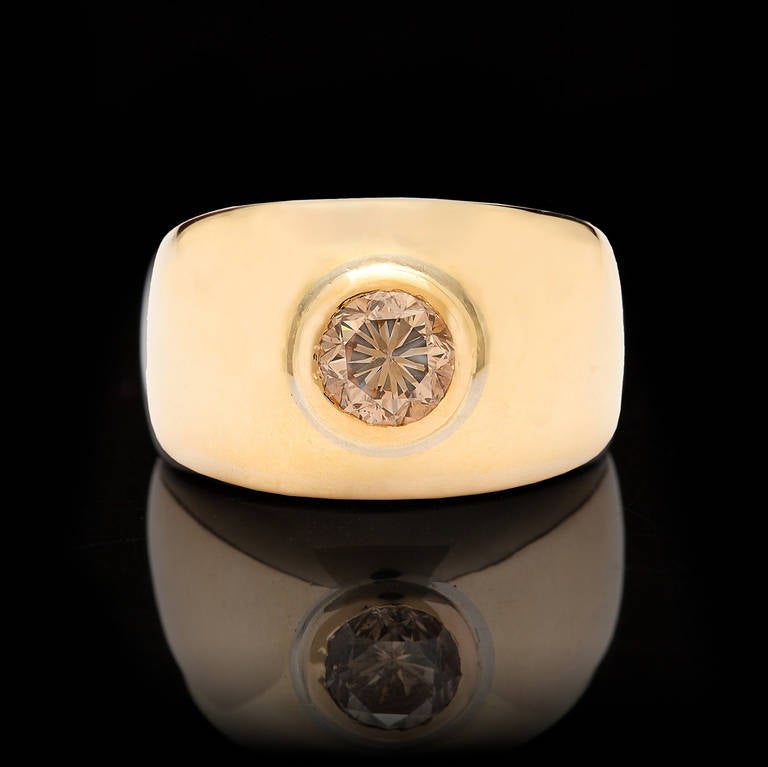 Handsome Gentleman's 14Kt Yellow Gold Ring Features a Bezel Set Pinkish Brown Diamond, for approximately 0.85ct. The ring is a size 6.0 and measures 12.5mm-4mm in width. The total weight is 7.3 grams.