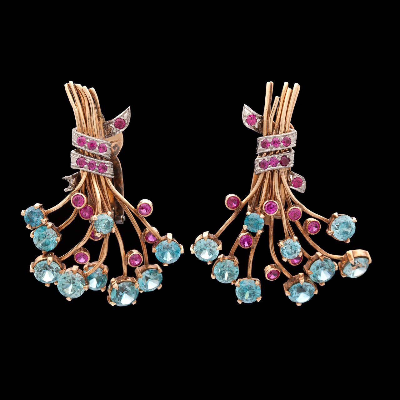 Retro J.E. Caldwell 18Kt Yellow Gold Bouquet Clip-on Earrings Adorned with Brightly Colored Blue Zircons and Rubies. Each earring measures 44mm in length and 36mm in width. They total 18.3 grams.