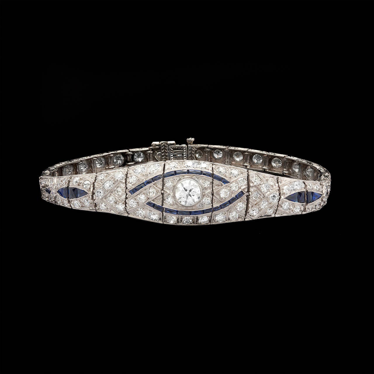 Finely Crafted Art Deco J.E. Caldwell Bracelet with an Intricate Pattern of Diamonds and Blue Sapphires. This piece has a total of 93 diamonds with a total carat weight of 3.60cts, the center stone 0.60ct. The bracelet is 7.25 inches long and