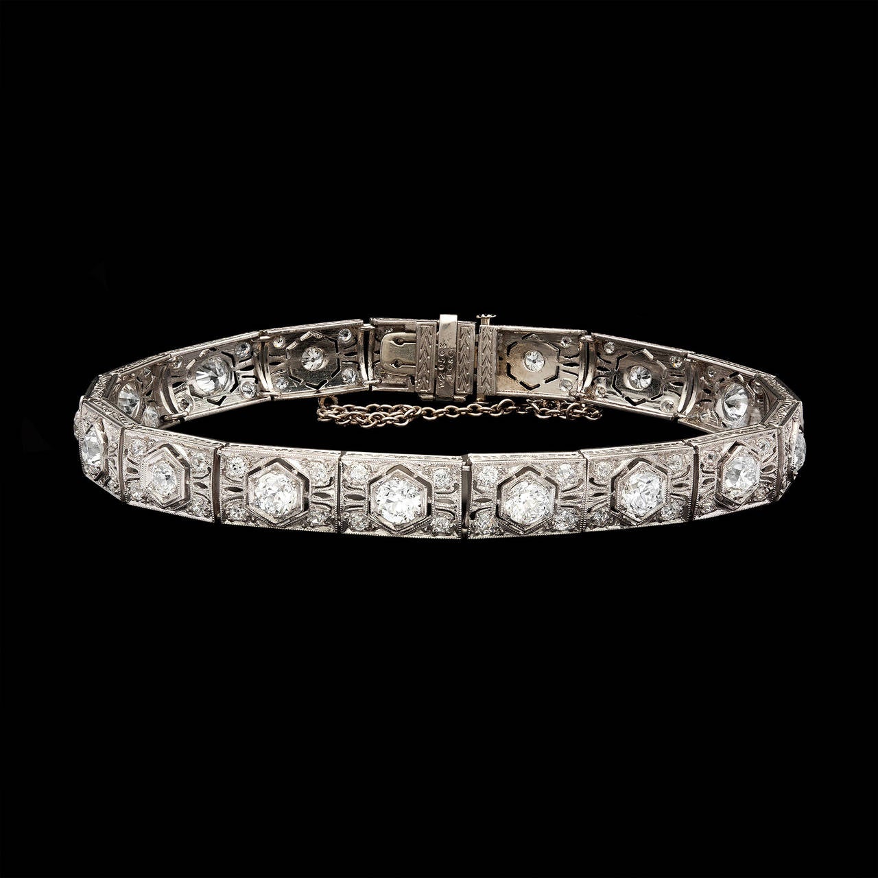 Art Deco J.E. Caldwell Platinum Bracelet Features 17 Old European Cut Diamonds of 4.50cts on Beautifully Crafted Links with Milgrain and Filigree Details. The main stones are enhanced by another 68 diamonds weighing 1.40cts. The bracelet is 8.25