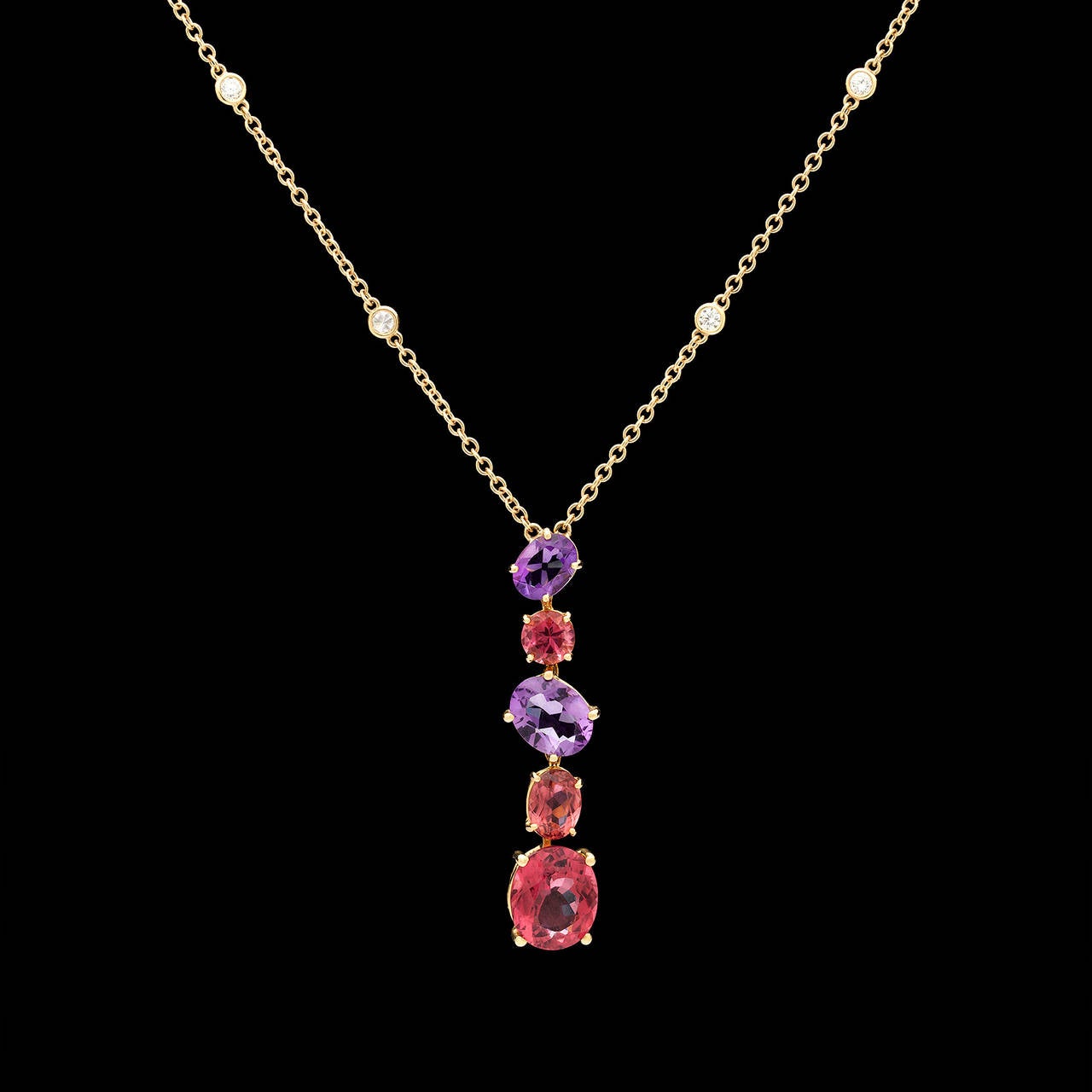 Contemporary Asprey Chaos Necklace Features a Five Stone Oval and Round Cut Multi Gem Pendant in Lovely Shades of Pink and Purple. The 1.19ct diamond adorned chain adjusts down from 17 inches to 15 inches in half size intervals. The necklace weighs
